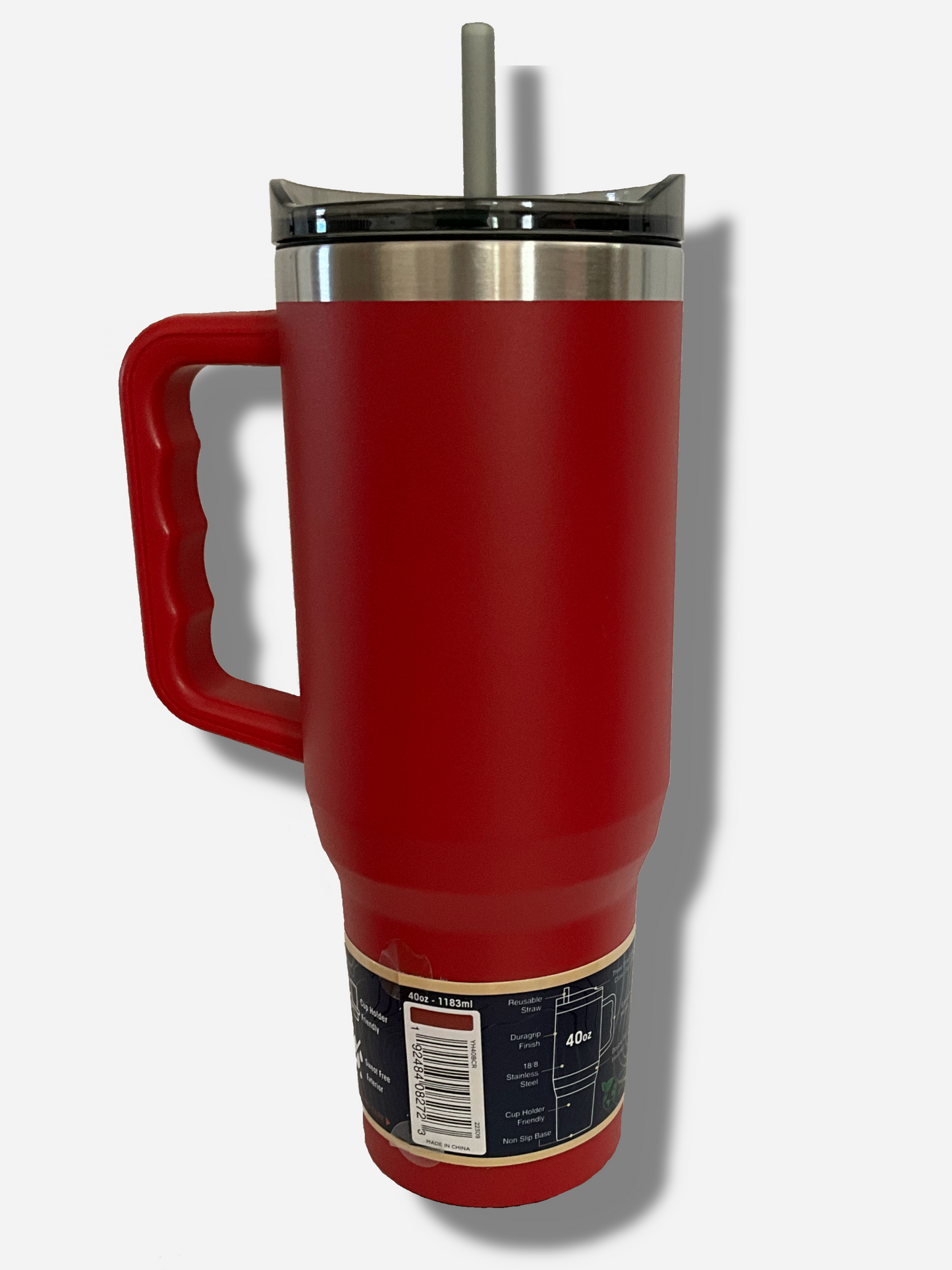 A picture of the back of a tall, red, sorta skinny tumbler. The surface is smooth and red, as it is red paint covering stainless steel. The handle, top, and straw are plastic. The top of the mug is lined with a stainless steel band. A paper wrapper around the bottom has a diagram that reads 40 oz, next to the barcode.