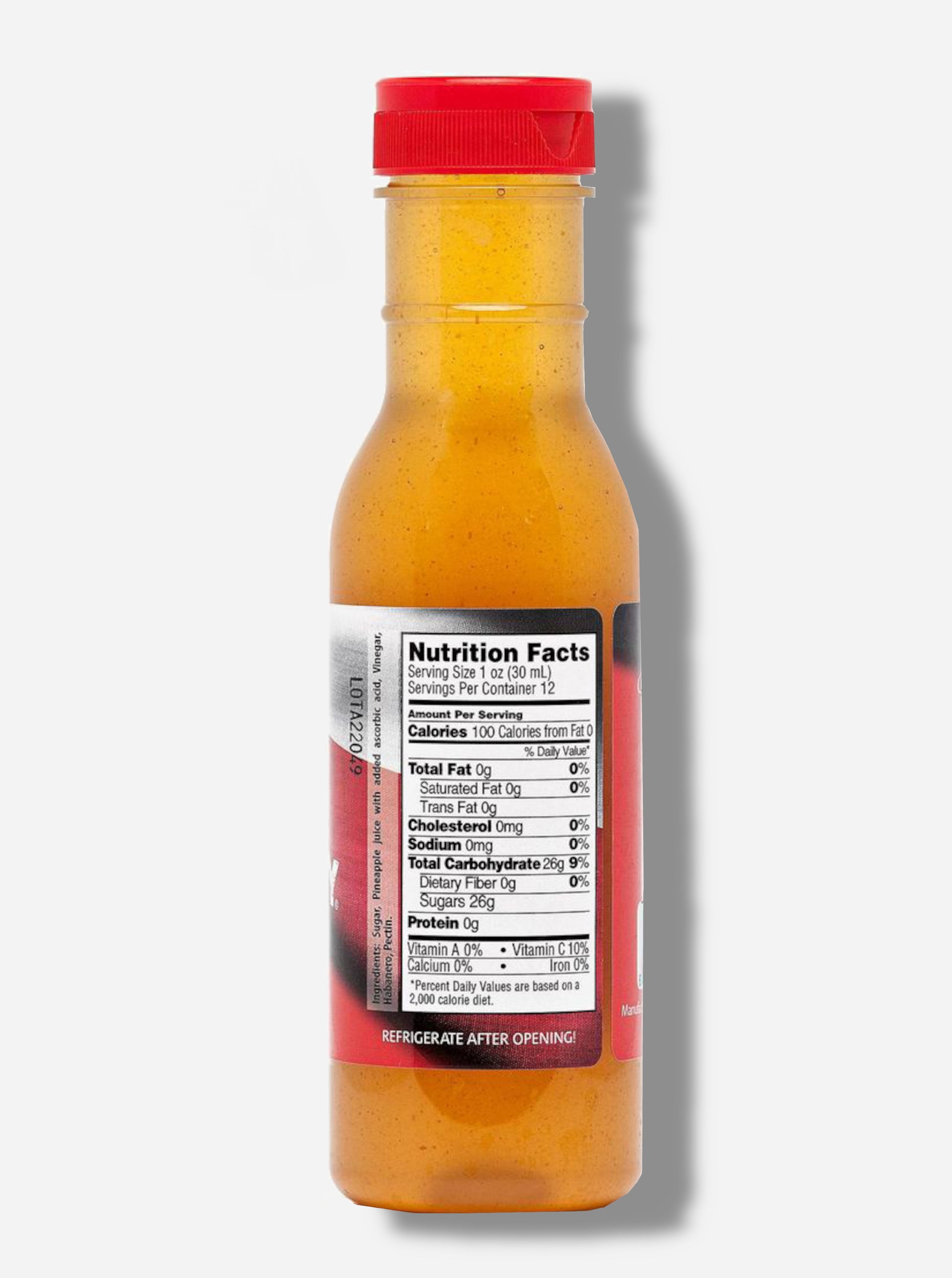 A picture of a the back of a plastic bottle of Texas Pepper Jelly's "The Original Rib Candy", Pineapple Habanero flavor.  The bottle is cylindrical and clear & the top is covered by a plastic red flip top.Inside the bottle is a orange-red thick fluid, with air bubbles suspended in the fluid.  The bottom of the label under the nutrition facts reads REFRIGERATE AFTER OPENING.