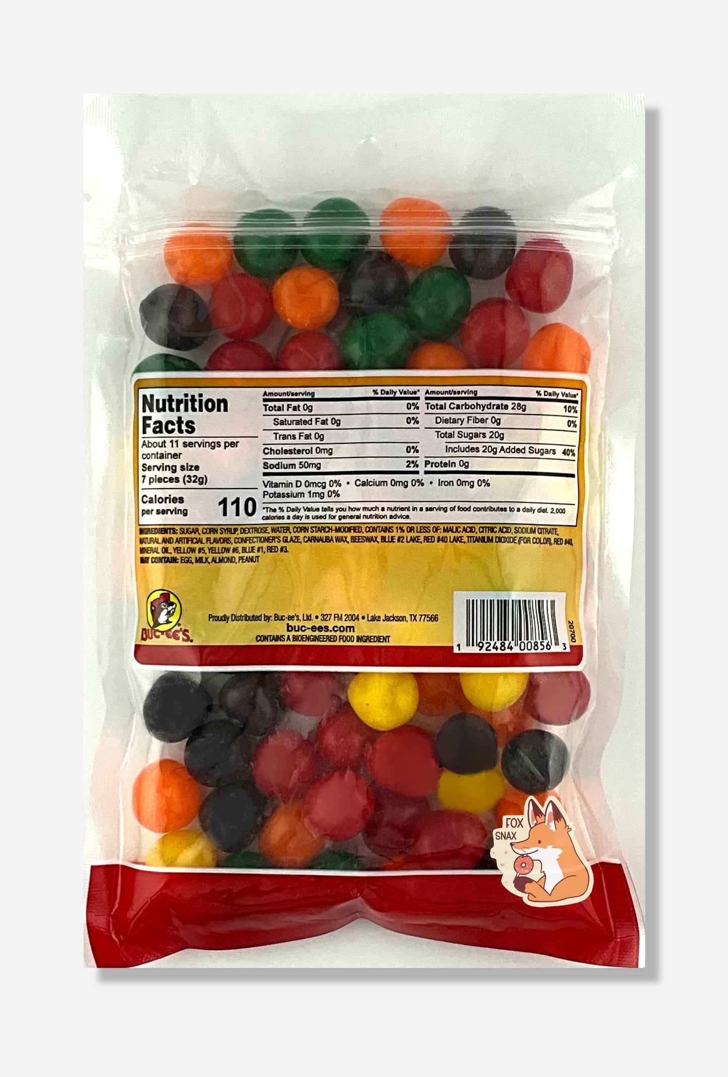 A picture of the back of a resealable bag of Buc-ee's Assorted Sours, which are sour and sweet candies. The sours inside are spherical, and are multiple shades of red, orange, yellow, green, and purple.