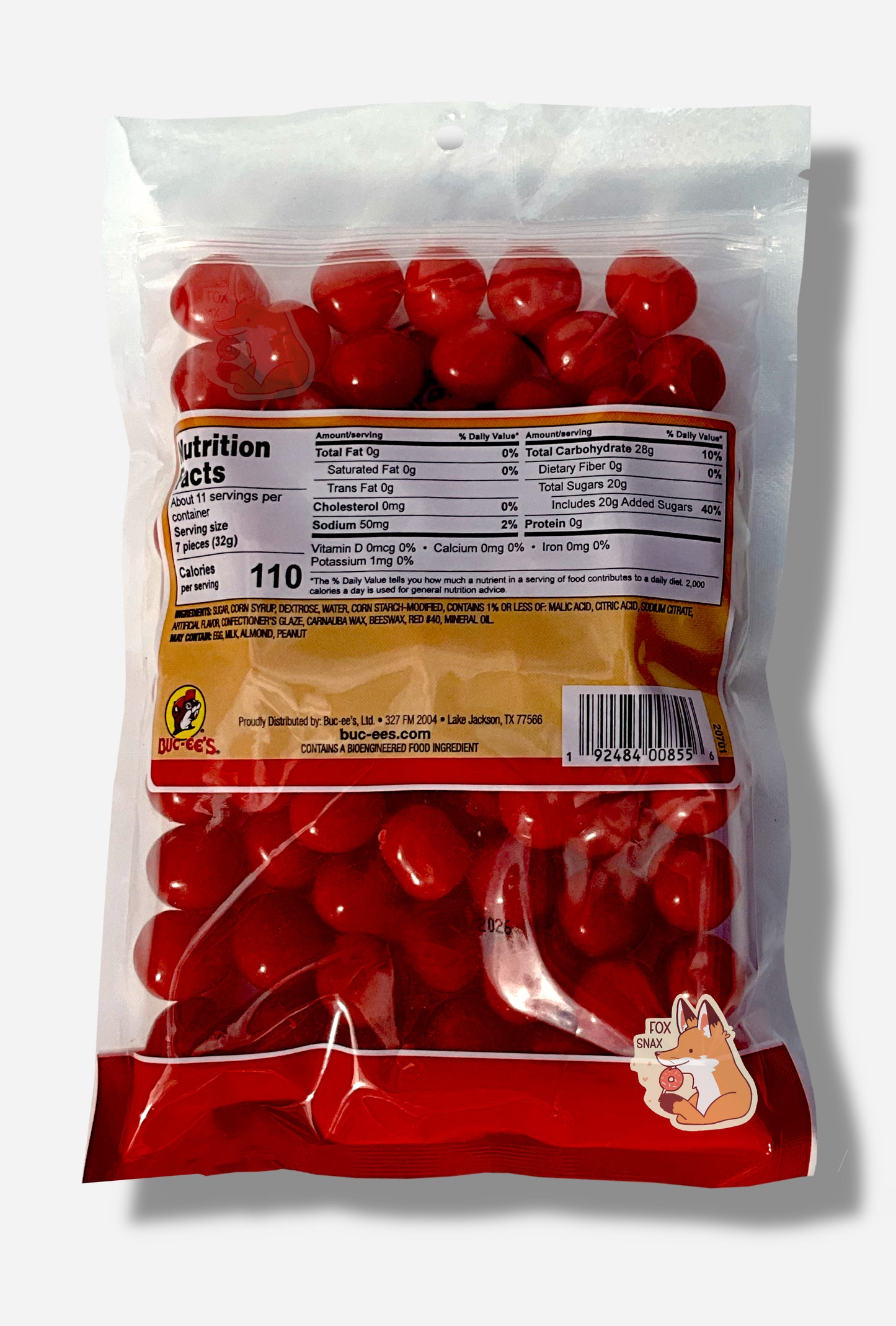 A picture of the back of a clear resealable bag of Buc-ee's Cherry Sours, which are bright red, sour and sweet spherical candies.