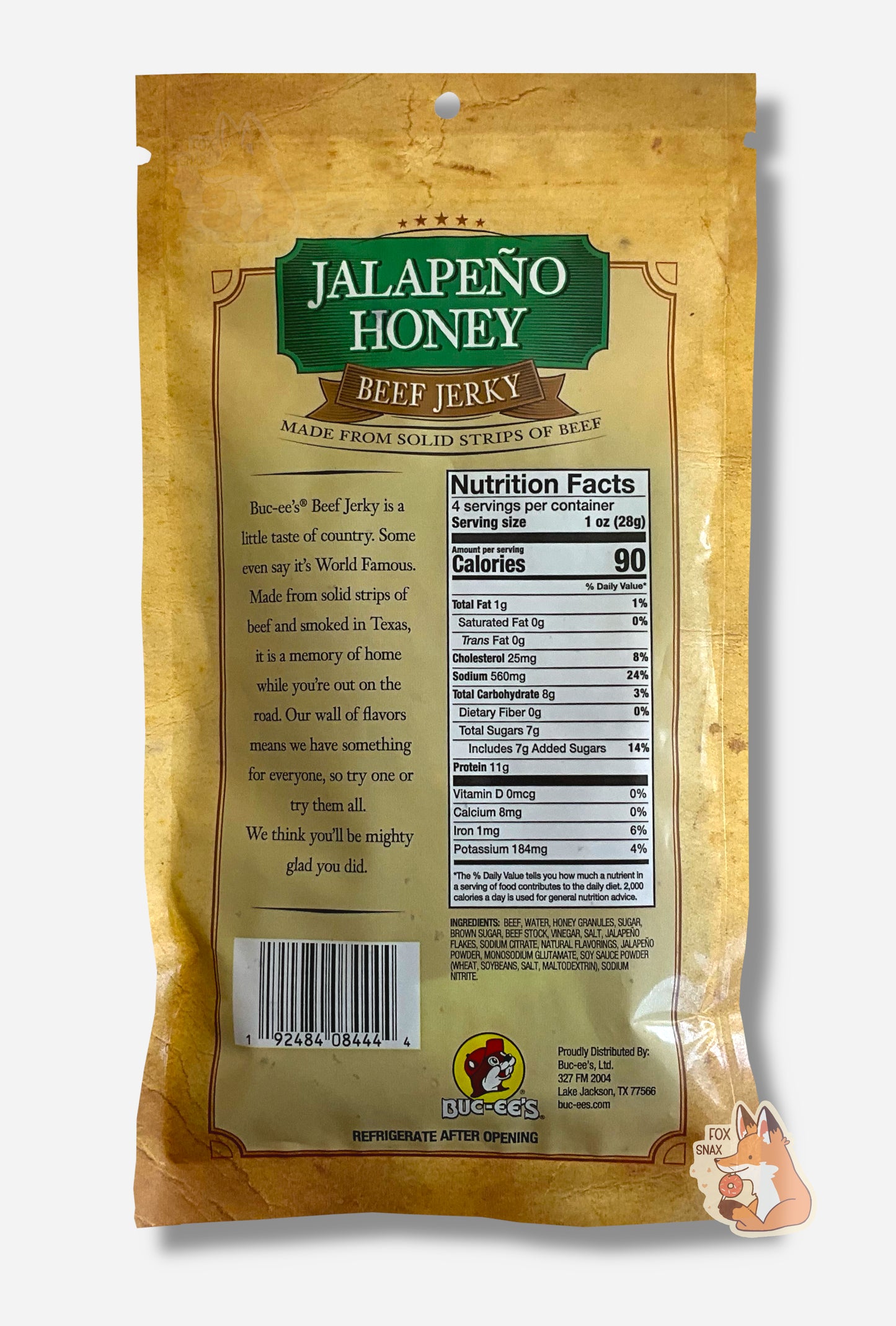 A picture of the back of a tan plastic bag of Buc-ee's Jalapeño Honey Beef Jerky. The green label underneath reads 'Buc-ee's Beef Jerky is a little taste of country. Some even say it's World Famous. Made from solid strips of beef and smoked in Texas, it is a memory of home while you're out on the road. Our wall of flavors means we have something for everyone, so try one or try them all. We think you'll be mighty glad you did.'