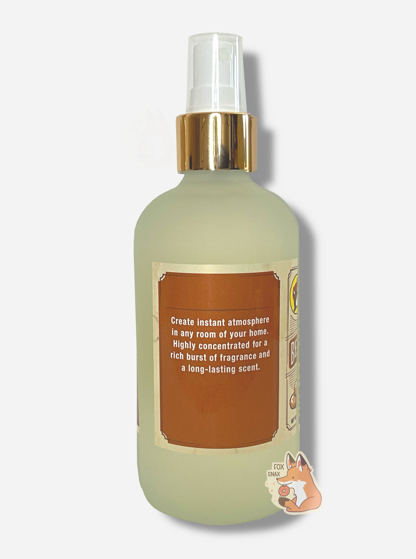Right side of spray bottle of Buc-ee's Beaver Nuggets Freshening Room Mist on a white background. The bottle is frosted glass with a white sprayer and gold label. The label reads: Create instant atmosphere in any room of your home. HIghly concentrated or a rich burst of fragrance and a long-lasting scent.