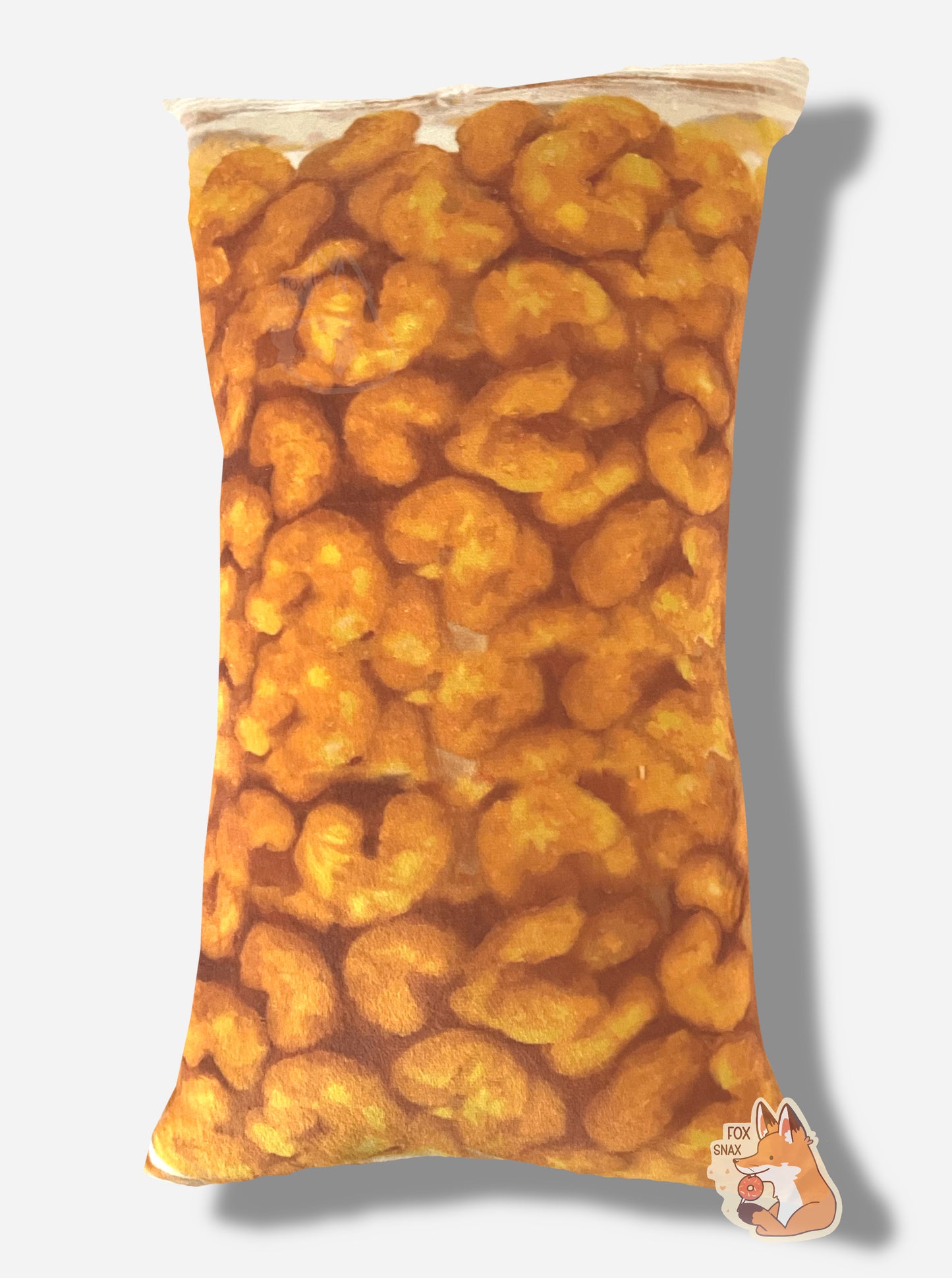 A picture of the back of a Buc-ee's Beaver Nuggets pillow. The pillow is a roughly rectangular shape, same as a bag of Beaver Nuggets. The surface of the pillow has brown/tan beaver nuggets printed on it.