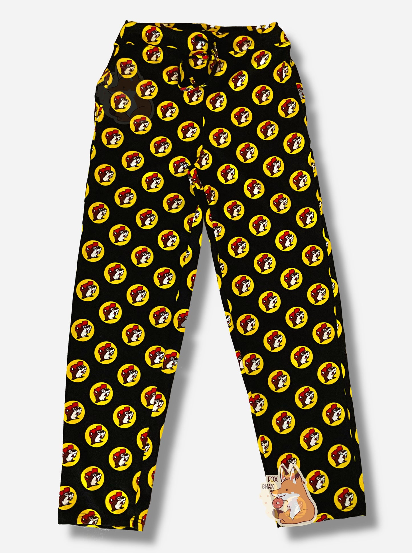 A picture of a pair of black pants. The pants are covered in Buc-ee's logos: a grinning beaver wearing a red ballcap, backlit by a yellow circle. A black drawstring can be seen at the waist of the pants.