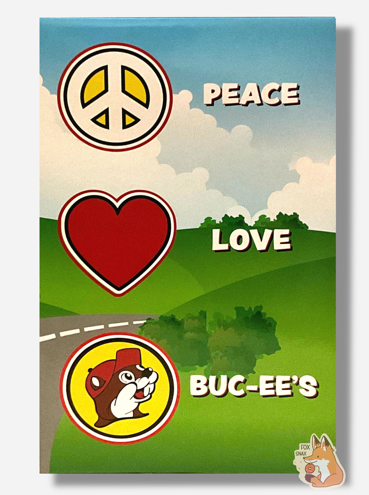 A picture of the back side of a box for a Buc-ee The Beaver Bobblehead. It shows a cartoon meadow with a road leading behind a hill. In large white text, it states PEACE (next to a peace sign), LOVE (next to a heart sign), and BUC-EE'S (next to a logo of Buc-ee The Beaver)
