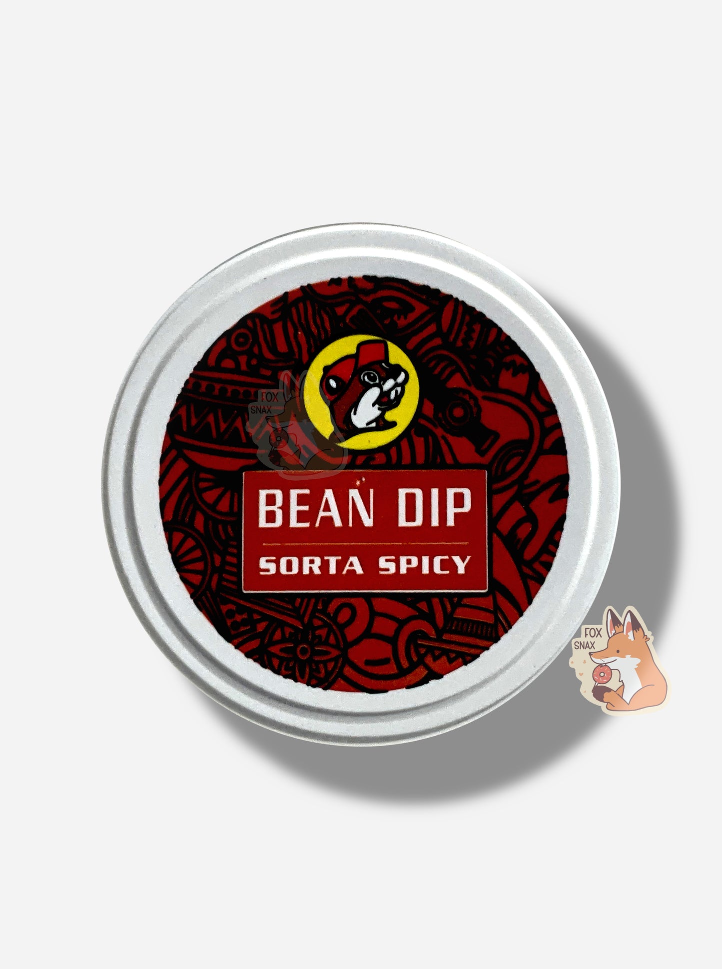 A picture of the top of a can of Buc-ee's Sorta Spicy Bean Dip. The top of the can has the Buc-ee's logo, then reads BEAN DIP ORIGINAL against a dark red lid background. Studding the background are various symmetrical shapes in black.