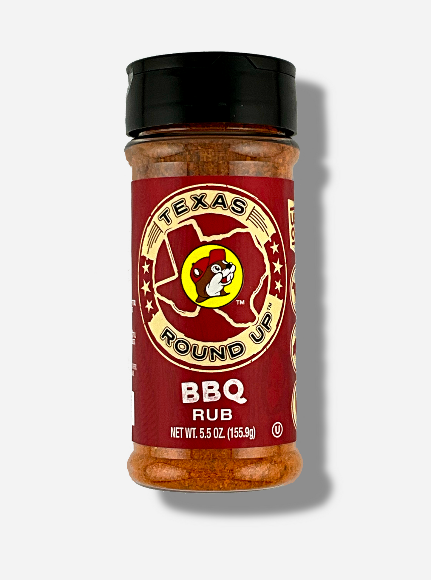 A picture of the front of a container of Texas Round Up BBQ Rub. The container has a black plastic flip lid, and a clear plastic body. The spices inside appear red/orange and black. The label reads TEXAS ROUND UP, with an outline of the state of Texas, with a picture of Buc-ee The Beaver in the middle. Beneath that, the red label reads in white text, BBQ Rub. Net Wt 5.5 Oz (155.9g).