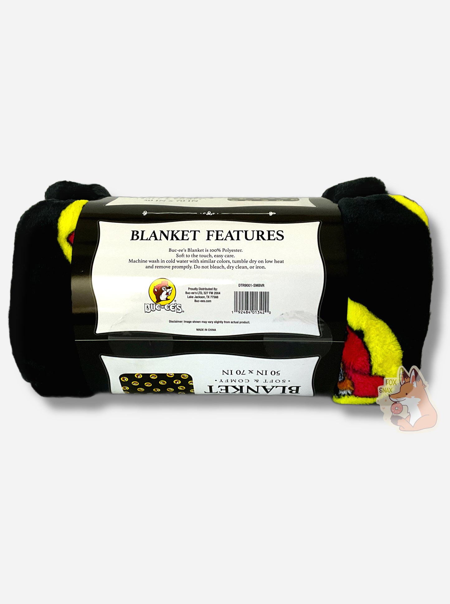 A picture of a soft black blanket covered in Buc-ee's logos. The logo is Buc-ee The Beaver, wearing a red ball cap against a yellow circle background. The label reads Buc-ee's Blanket is 100% Polyester. Soft to the touch, easy care. Machine wash in cold water with similar colors, tumble dry on low head and remove promptly. Do not bleach, dry clean, or iron.