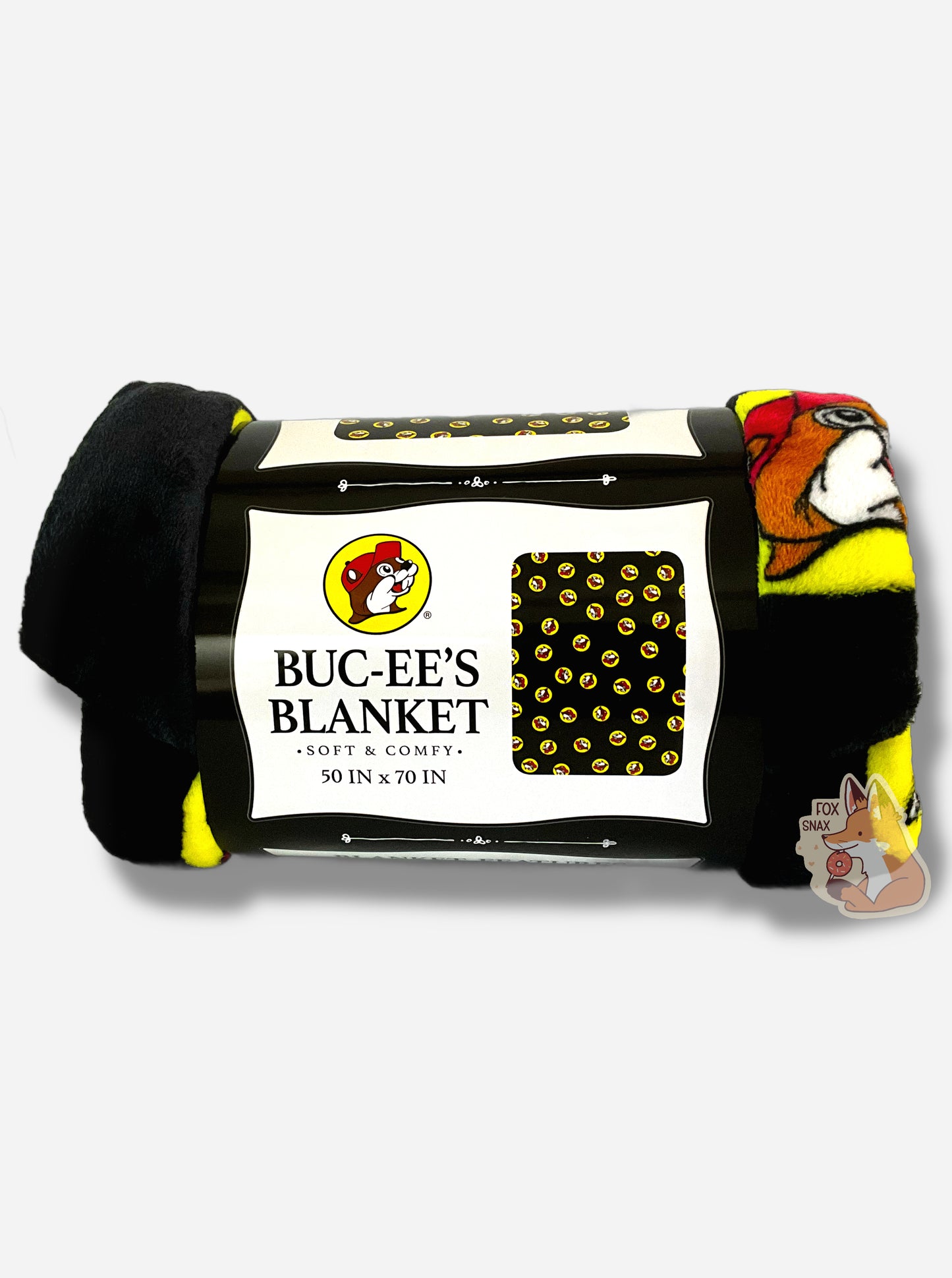 A picture of a soft black blanket covered in Buc-ee's logos. The logo is Buc-ee The Beaver, wearing a red ball cap against a yellow circle background. The label reads BUC-EE'S BLANKET *SOFT AND COMFY* 50 IN x 70 IN
