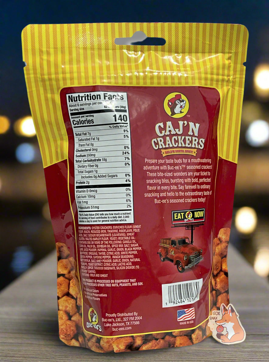 A picture of a the back of a metallic bag of Buc-ee's Caj'N Crackers. It reads "Prepare your taste buds for a mouthwatering adventure with Buc-ee's TM seasoned crackers! These bite-sized wonders are your ticket to snacking bliss, bursting with bold, perfected flavor in every bite. Say farewell to ordinary snacking and hello to the extraordinary taste of Buc-ee's seasoned crackers today!" The background is of a well-lit dock by the bayou.