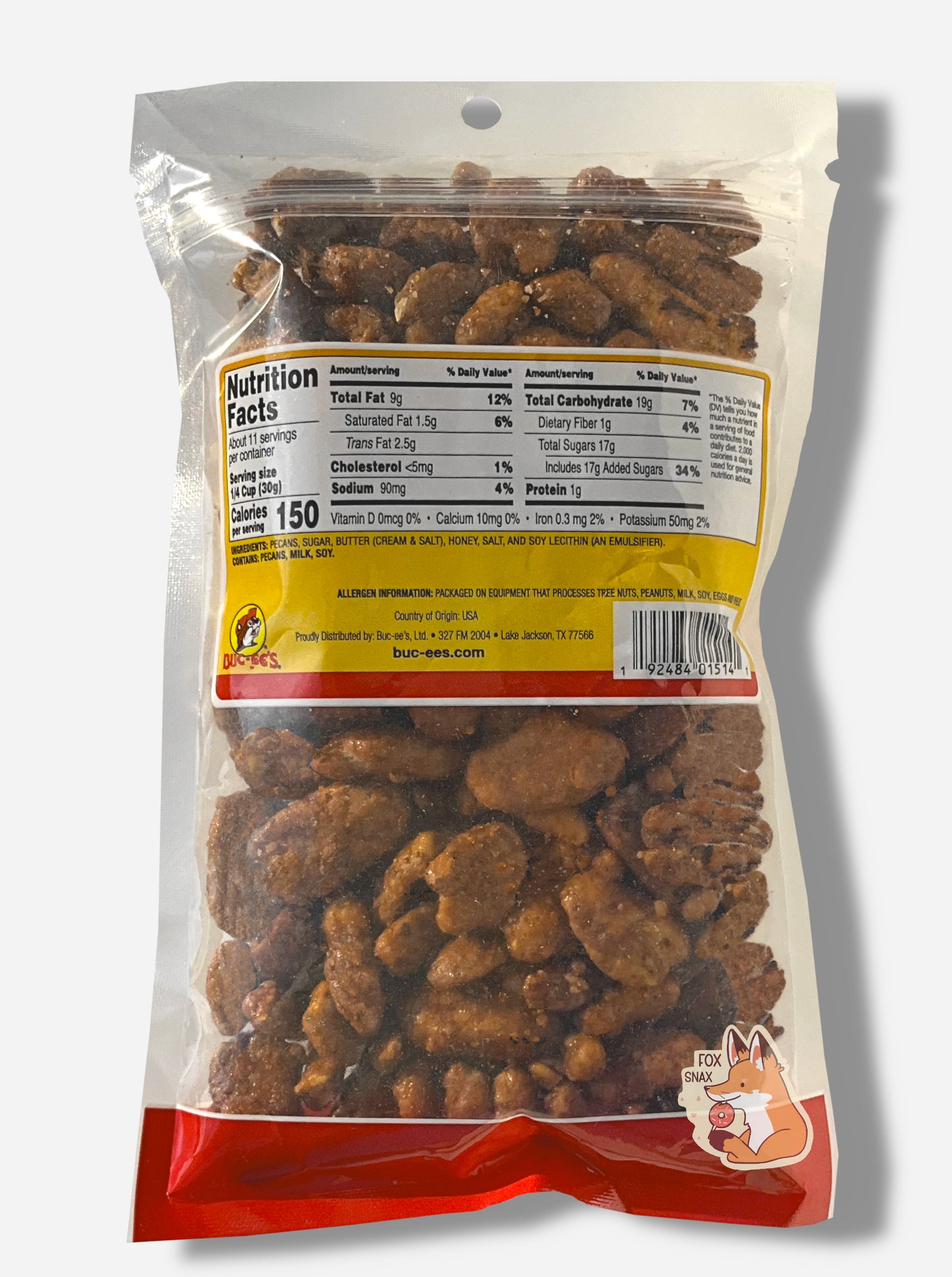 A picture of the back of a clear plastic bag of Buc-ee's Honey Toasted Pecans. Inside the bag are a large number of dried pecans, covered in brownish sugary material.