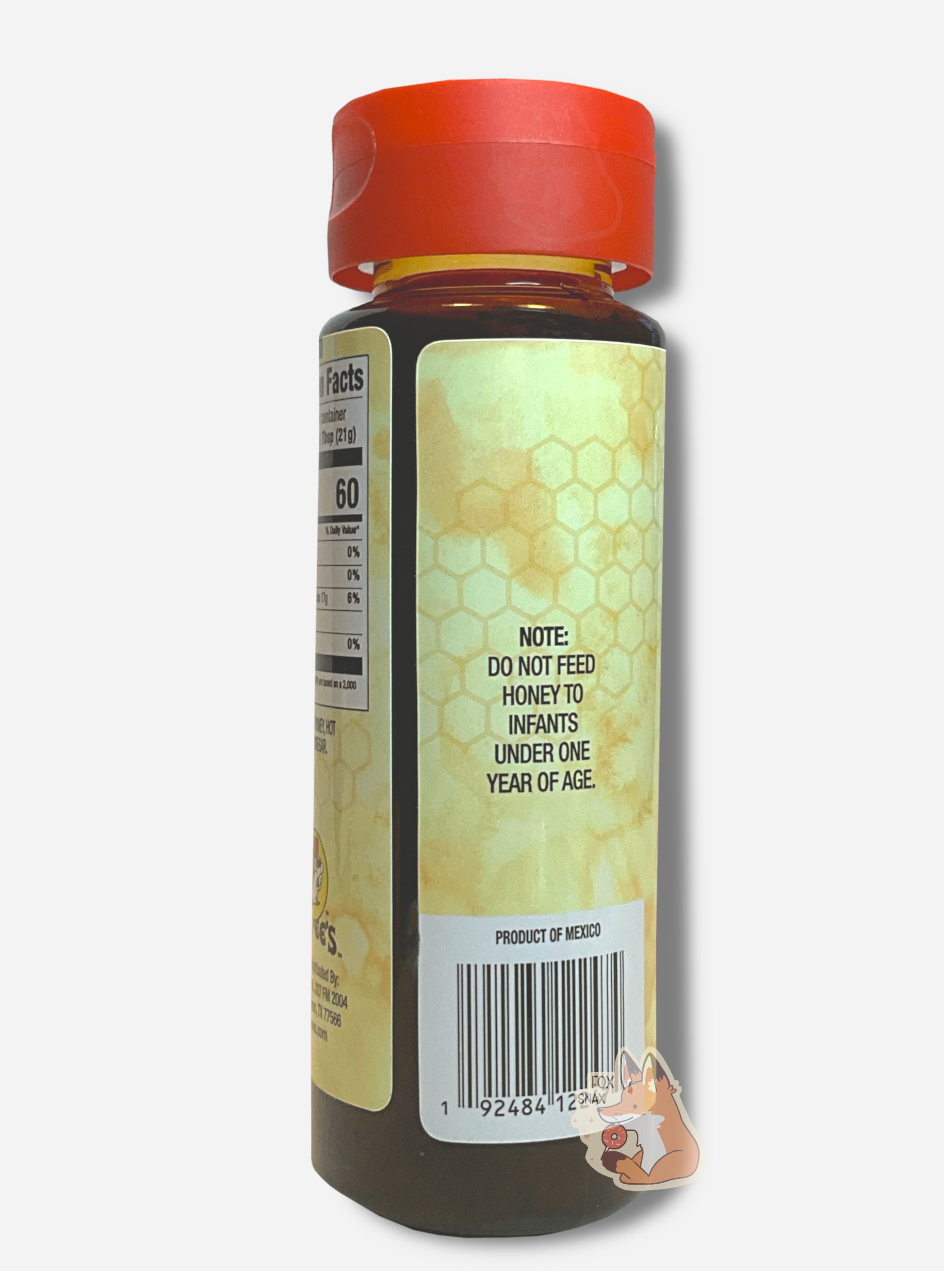 The back of a plastic bottle of Buc-ee's Hot Honey.  The top of the bottle is a plastic red flip top.  The bottom is clear plastic; the brown/yellow honey inside can be seen.  A label surrounds the bottle, which reads NOTE: DO NOT FEED HONEY TO INFANTS UNDER ONE YEAR OF AGE, then PRODUCT OF MEXICO.