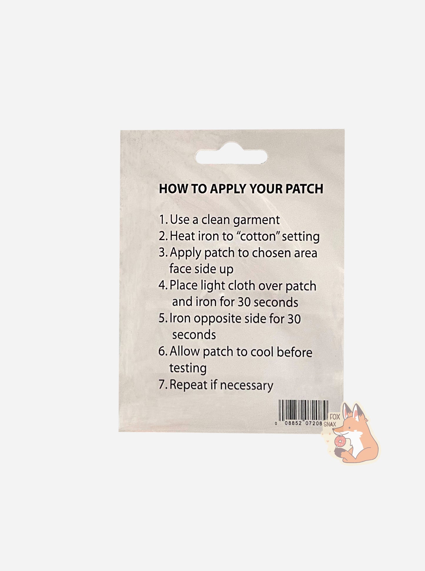 A picture of the back of iron-on patch package. It reads: HOW TO APPLY YOUR PATCH, then "1. Use a clean garment", then "2. Heat iron to 'cotton' settings", then "3. Apply patch to chosen area face side up", then "4. Place light cloth over patch and iron for 30 seconds", then "6. Allow patch to cool before testing", then "7. Repeat if necessary".