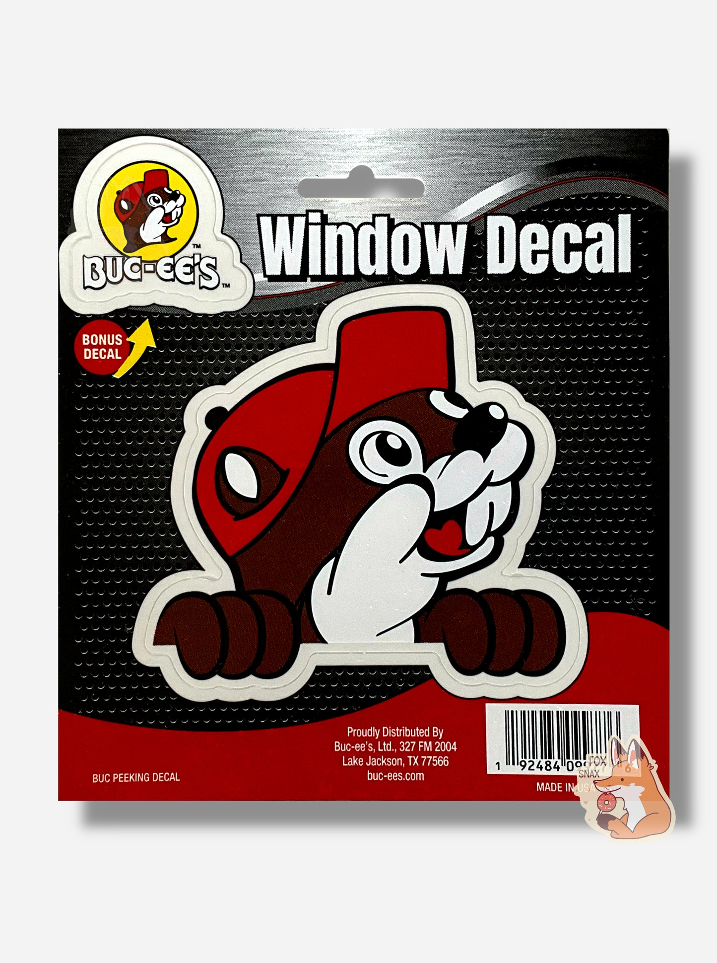 A picture of a window decal sticker for a vehicle. The decal is of Buc-ee the Beaver, and resembles most of the Buc-ee's logo - a cute beaver wearing a red ball cap, looking to the right and smiling. His two hands can be seen, with fingers curled over the edge. The sticker's backing reads WINDOW DECAL. On the top left of the decal is another bonus decal - this one is of the Buc-ee's logo and reads BUC-EE'S in white font.
