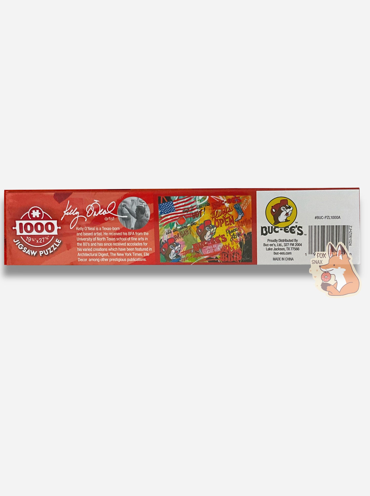 A picture of the side of a box of an extremely colorful puzzle. The side reads 1000 (pieces), 19 3/4 x 27 3/4. There is a small biography on the artist, Kelly O'Neal, and a picture of them working on a painting in black and white. A smaller version of the puzzle itself is shown on the side here, same as the front of the box, next to a Buc-ee's logo and address.