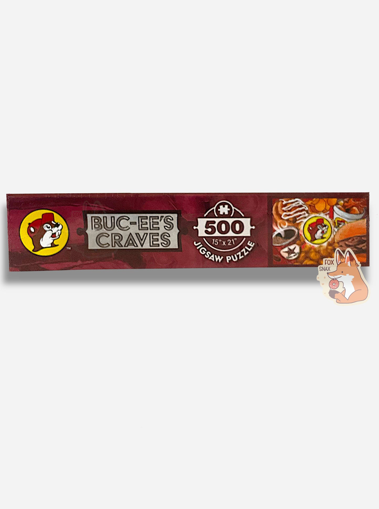 A picture of the side of a box of a jigsaw puzzle. The side has a Buc-ee's logo, then the text ALWAYS OPEN, then 500 (pieces), 15 x 21. A smaller version of the puzzle itself is shown on the side here, same as the front of the box.
