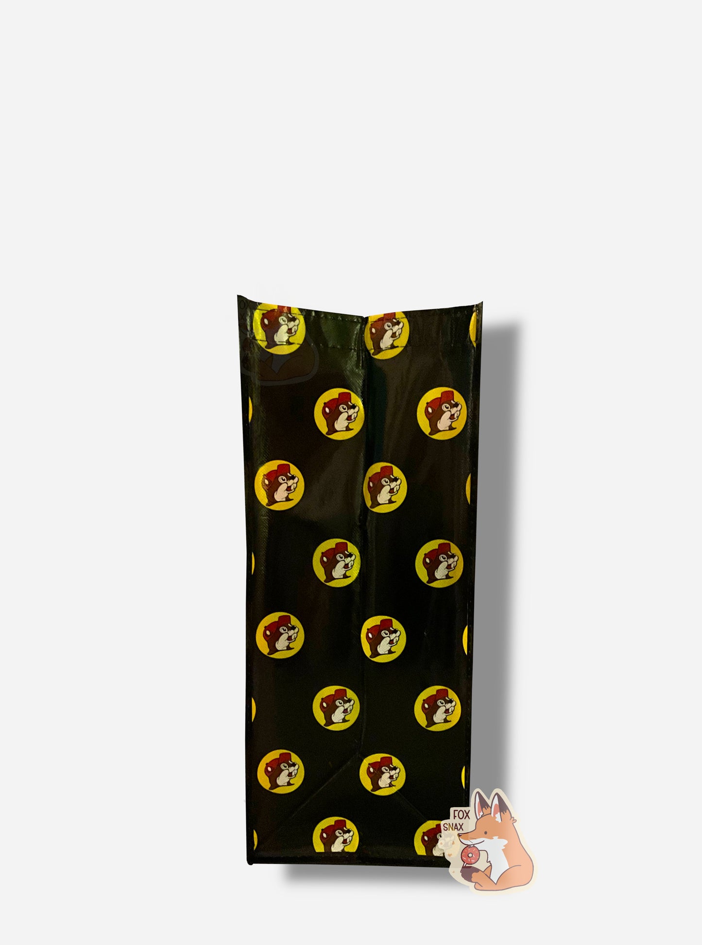 A picture of a the side of a large rectangular plastic shopping bag. The side of the bag has a black background, studded with Buc-ee The Beaver logos.