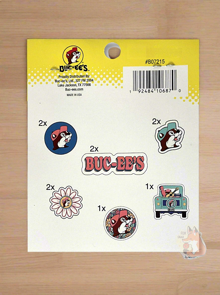 A picture of the back of Buc-ee's Sticker Pack, "Stick them on everything, even the kitchen sink". The label indicates there are 10 peel & stick decals in the clear plastic bag. The sticker pack is sitting on a kitchen table.