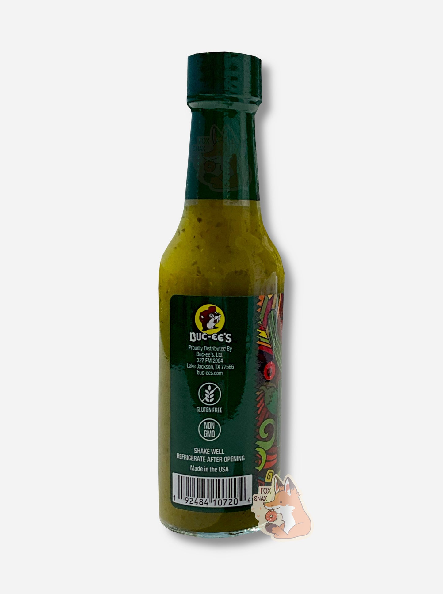 A picture of a small, tall glass bottle of hot sauce. The top of the bottle is sealed with a plastic top. The back reads GLUTEN FREE, NON GMO, then SHAKE WELL and REFRIGERATE AFTER OPENING. Made in the USA. The sauce inside is dark green/green with darker green flecks.