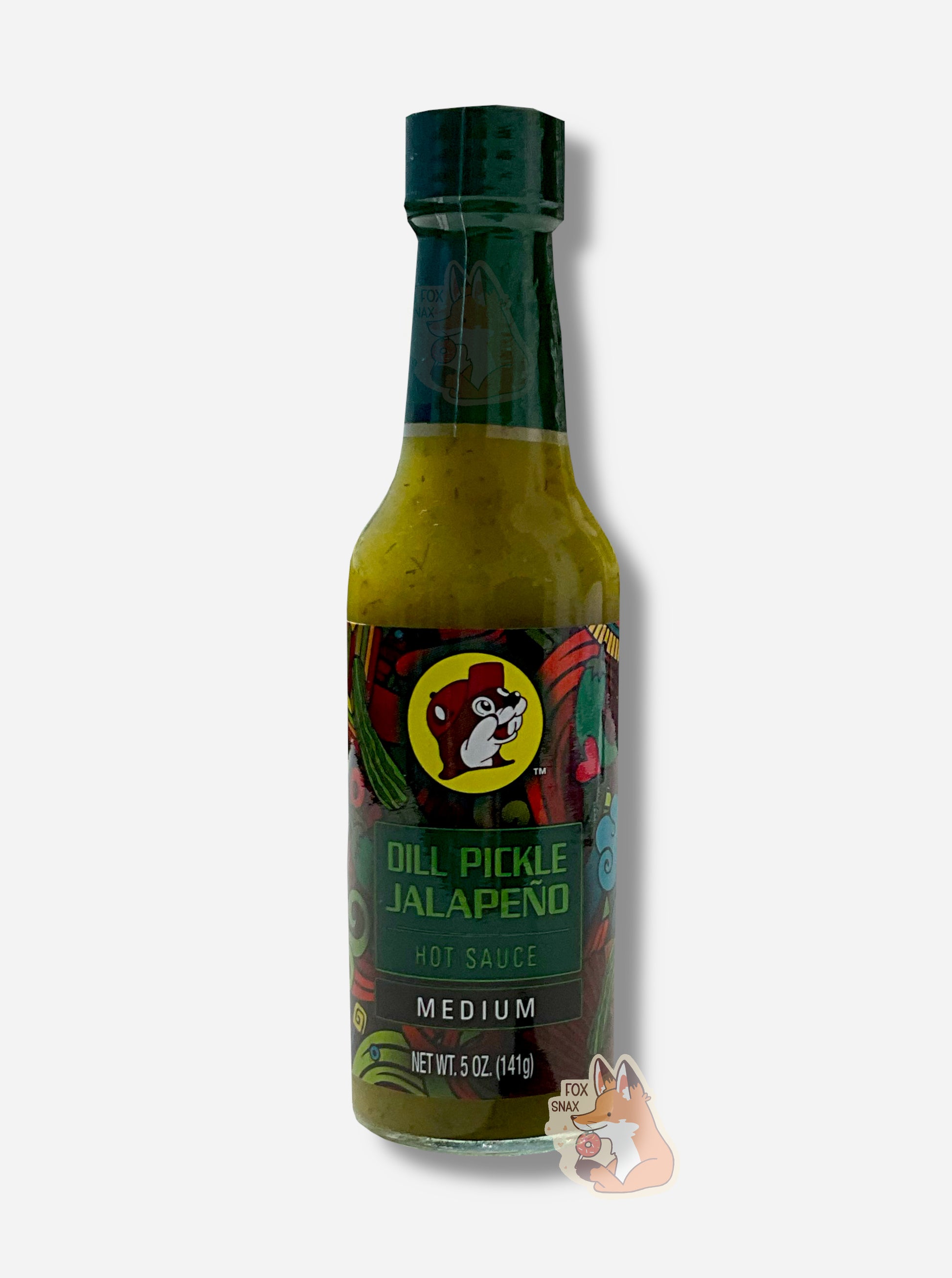 A picture of a small, tall glass bottle of hot sauce.  The top of the bottle is sealed with a dark green plastic cover on a black cap.  The front label of the bottle reads DILL PICKLE JALAPENO, MEDIUM.  The Buc-ee's logo can be seen on the front; the background is a fairly busy abstract artwork featuring several pickles and chilis. The sauce inside is a dark green/green  with smaller green dots.