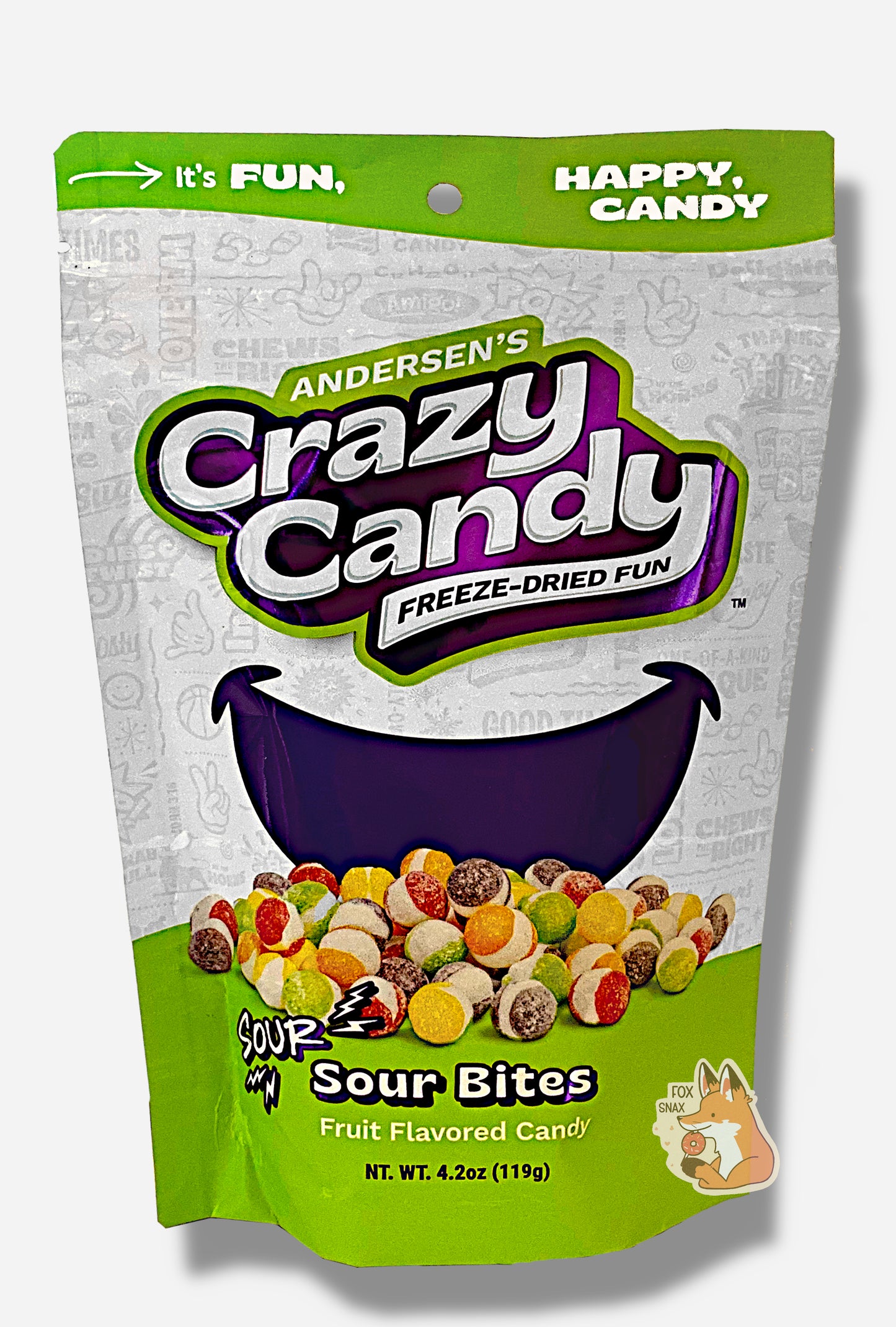 A large bag of Andersen's Sour Bites. The front of the bag also says Sour Sour Bites, Net Weight 4.2 oz. It's Fun, Happy, Candy. The top and bottom of the bag are green, and the background is a large purple smile against a white background.