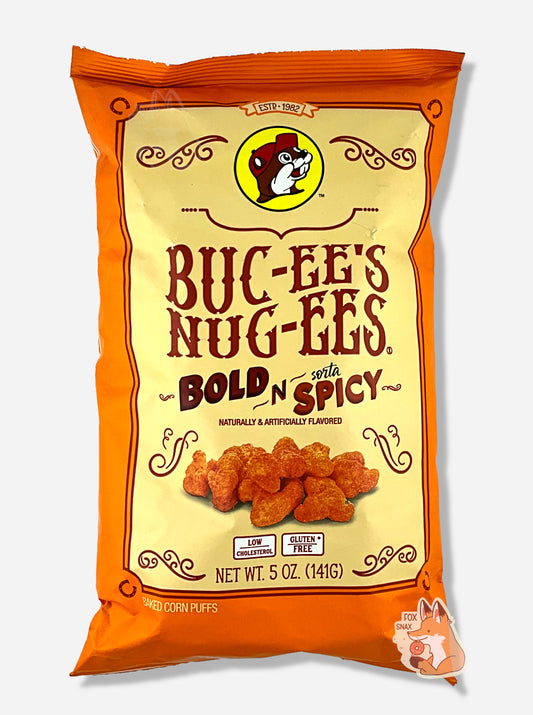 A picture of the front of a opaque, orange and yellow bag of Buc-ee's Nug-ee's Bold N Sorta Spicy, which are puffed corn snack with spicy flavors, and has a picture of Buc-ee the Beaver on it.  The bag reads: Naturally & Artificially Flavored.  Low Cholesterol.  Gluten Free.  Baked Corn Puffs.