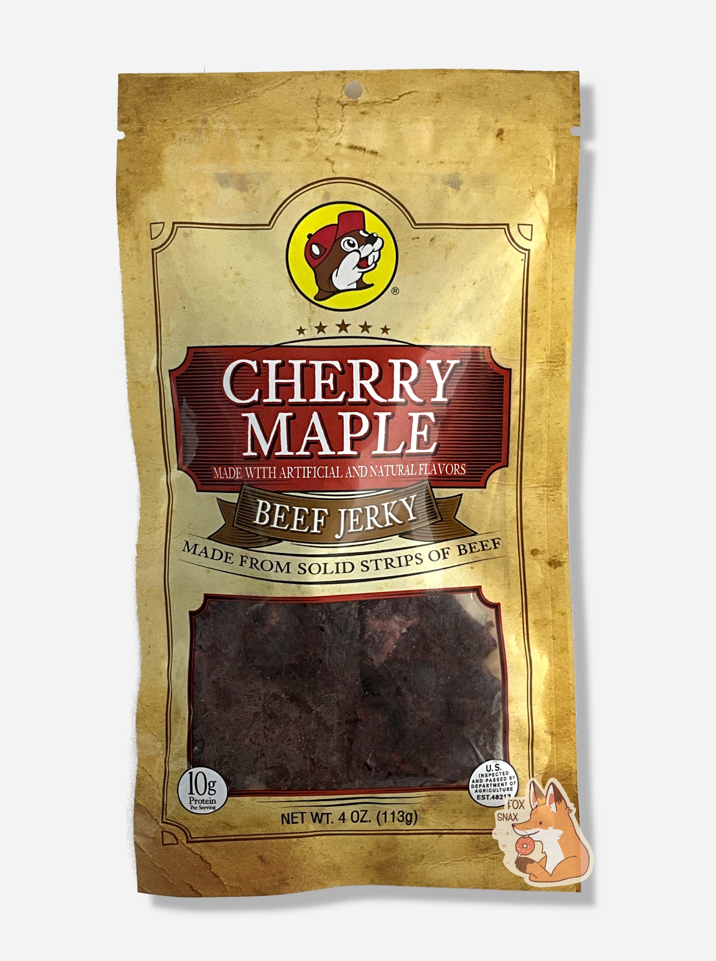 A picture of the front of a tan plastic bag of Buc-ee's Cherry Maple Beef Jerky. The logo is in dark red with white text.The label underneath reads 'Made From Solid Strips Of Beef'.A small window on the bottom of the bag shows the dark brown/red dried jerky inside. The bag has a picture of Buc-ee the Beaver on it.