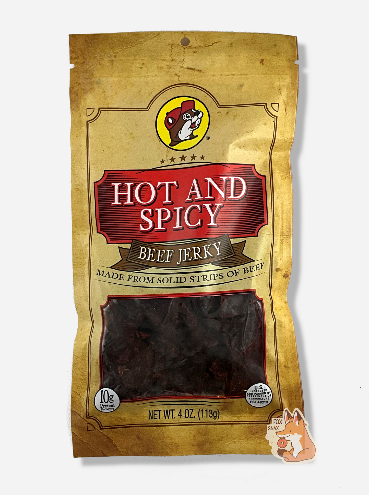A picture of the front of a tan plastic bag of Buc-ee's Hot And Spicy Beef Jerky. The logo is in bright red with white text.The label underneath reads 'Made From Solid Strips Of Beef'.A small window on the bottom of the bag shows the dark brown/red dried jerky inside. The bag has a picture of Buc-ee the Beaver on it.