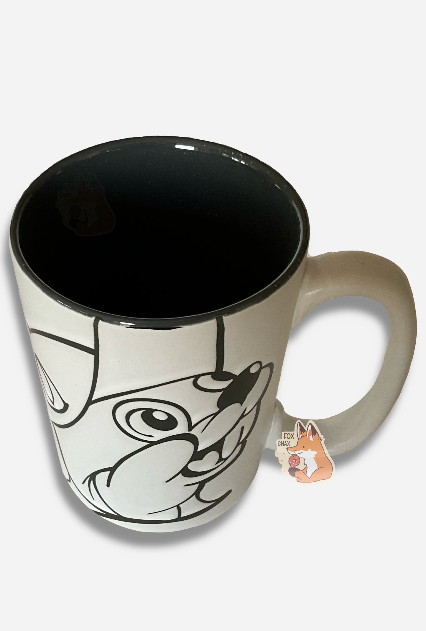 A picture of a ceramic, grey and white coffee mug. The mug prominently features a picture of Buc-ee The Beaver on the front and back, in grey. The interior of the mug is a dark grey as well, and rest of the mug is white.