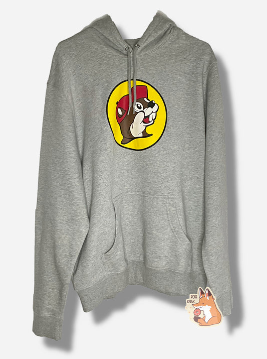 A picture of a grey cotton/polyester hoodie sweatshirt.  The dead center of the shirt shows the Buc-ee's logo: a jolly, brown and white furred beaver with a grin and a significant overbite, wearing a red ball cap, against the background of a yellow circle.  The bottom of the hoodie has a spot for warming one's hands, the neck has a drawstring to pull the opening of the hoodie tighter.