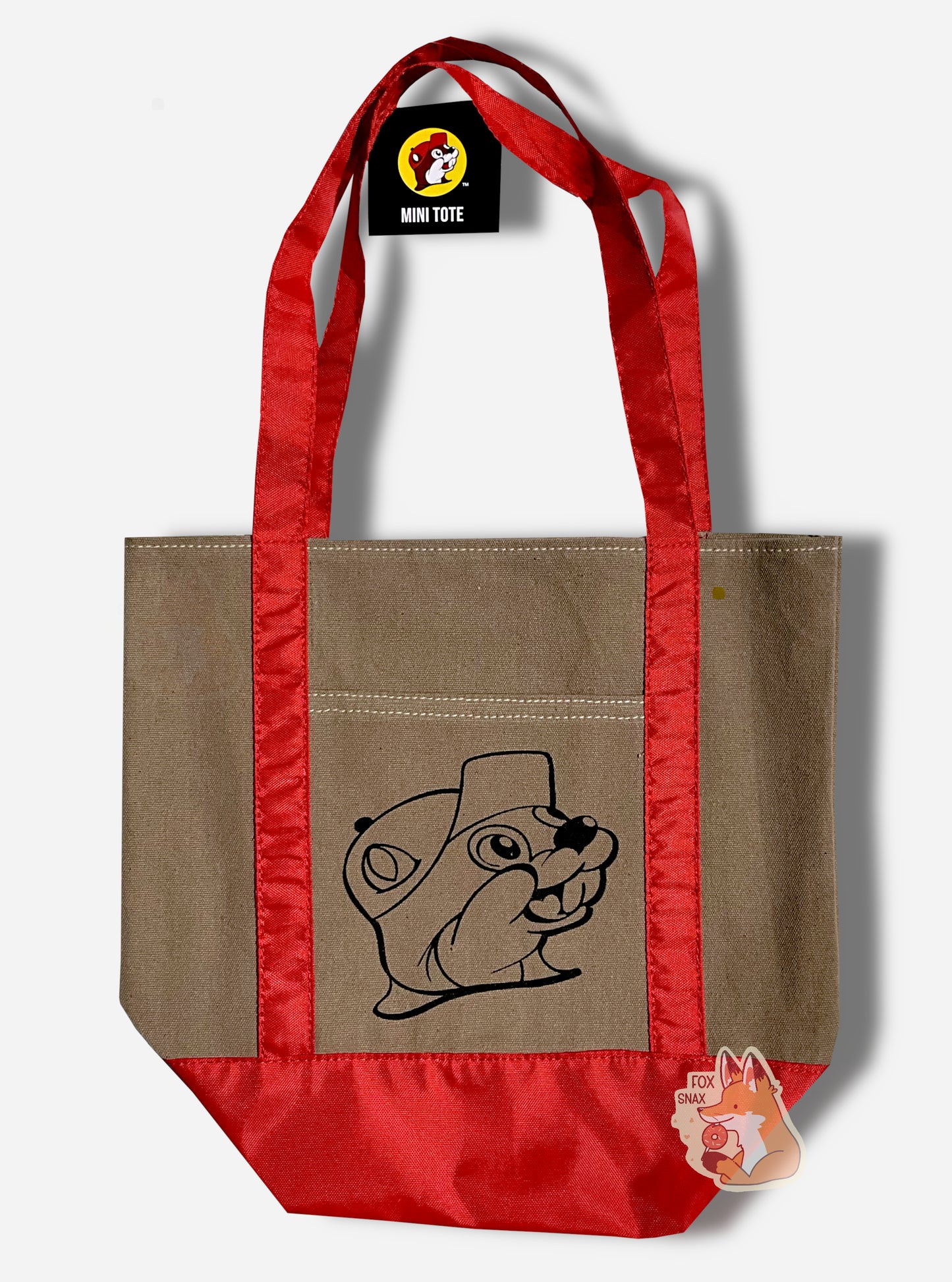 Picture of a the back of a small tote bag, with shiny red red cloth straps. In the center of the bag is a black outline of Buc-ee The Beaver: a jolly beaver wearing a ballcap and a buc-toothed smile.