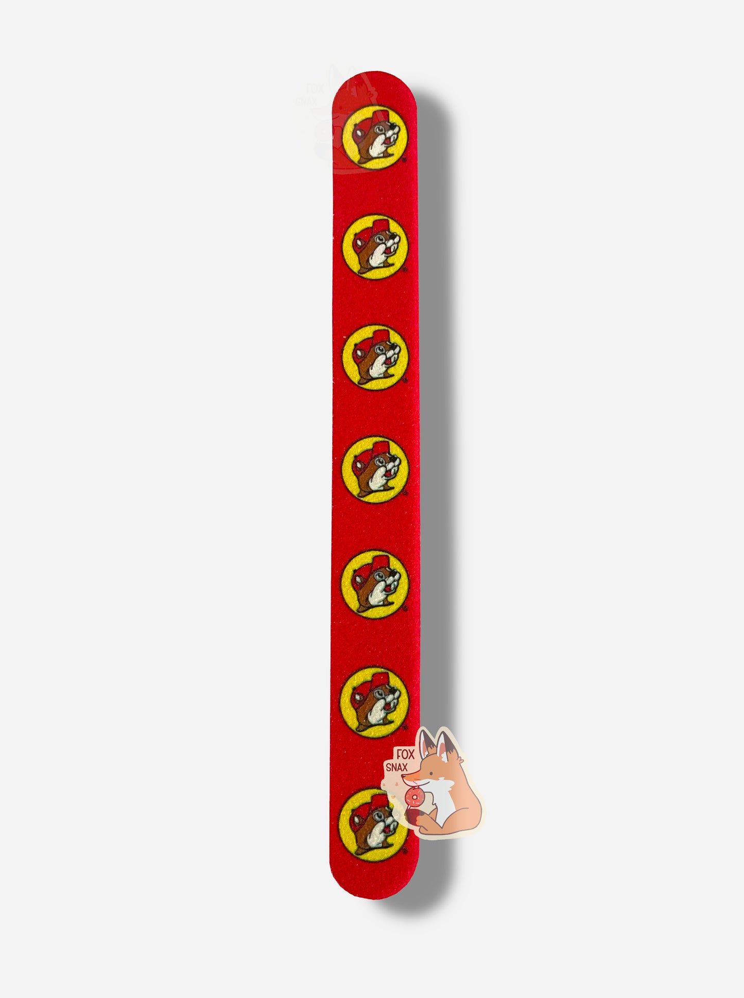A picture of a yellow and red (this side is red, the other yellow) nail file with six Buc-ee the Beaver logos on it, evenly spaced from top to bottom. Buc-ee is smiling and wearing a red ballcap.