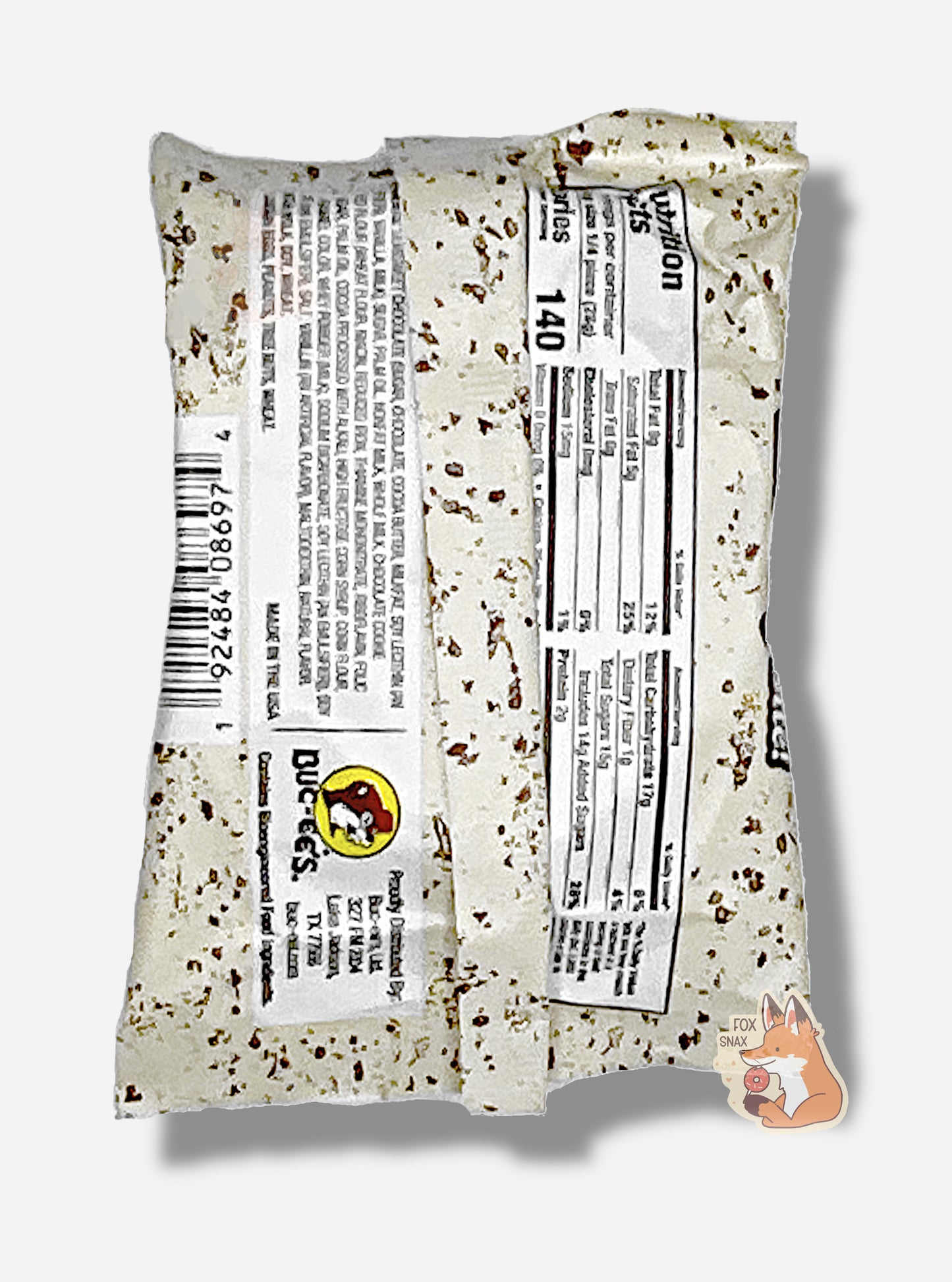 A picture of the back of a package of a dark chocolate cookies and cream Buc-ee's OverBite. The package is metallic and white, with brown flecks, and has a small picture of the Buc-ee's logo on the back. A picture of a package of a dark chocolate cookies & cream Buc-ee's OverBite.