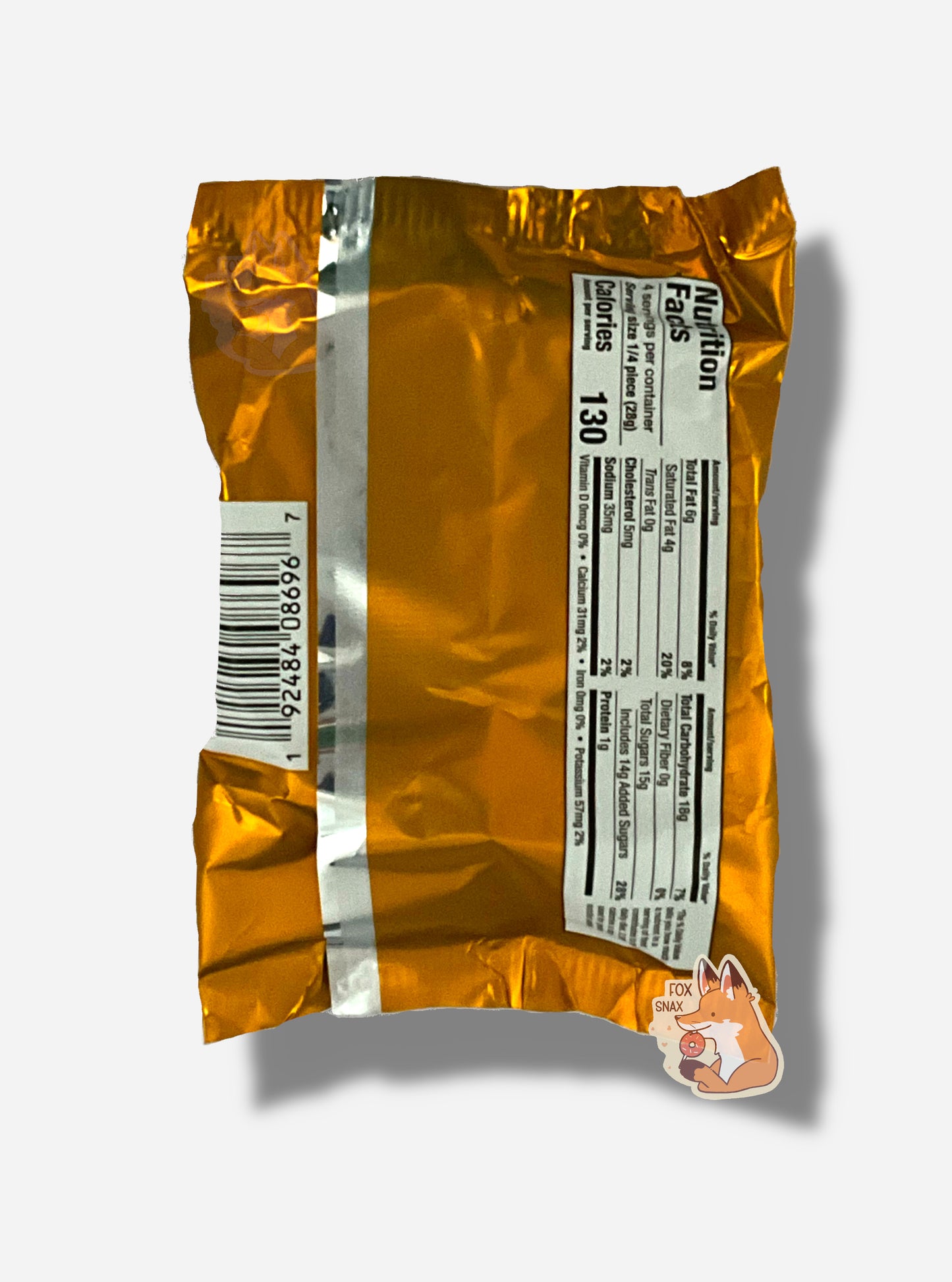 A picture of the back of a package of a dark chocolate peanut butter Buc-ee's OverBite. The package is metallic and tan/light orange.