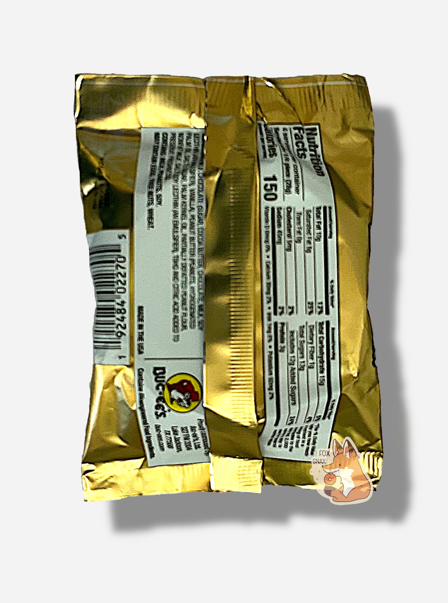 A picture of the back of a package of a chocolate peanut butter Buc-ee's OverBite. The package is metallic and tan, and has a small picture of the Buc-ee's logo on it.
