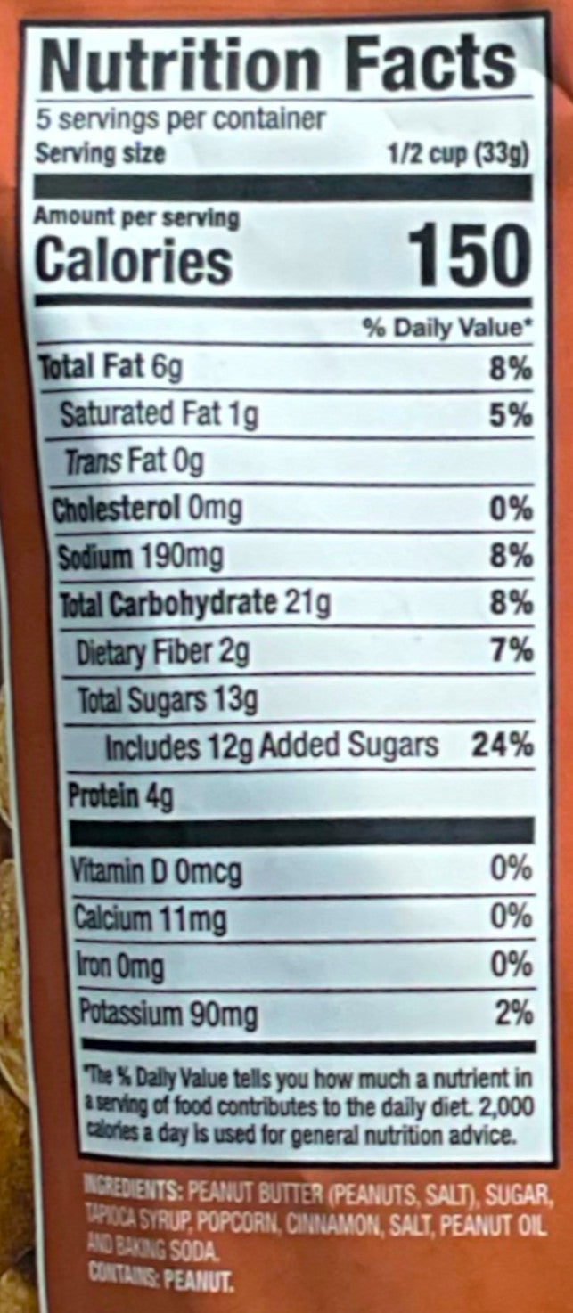 A picture of a orange/brown bag of Buc-ee's Peanut Butter & Caramel With Cinnamon Popcorn. Nutrition facts, and ingredients can be seen.