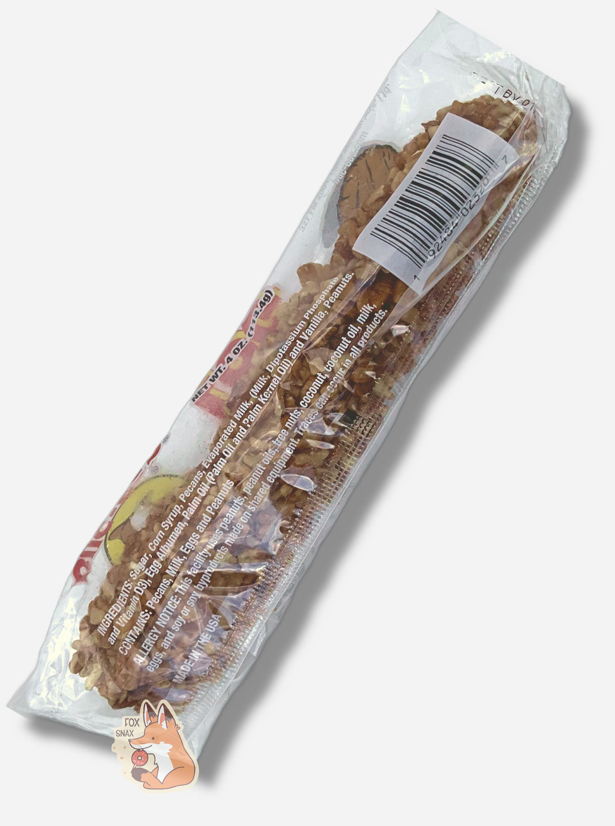 A picture of the back of a long, rectangular, clear plastic package of Buc-ee's Pecan Log. Inside the package is a long thin cylinder; the surface of the cylinder is covered in small chopped bits of pecans. The writing on the package show ingredients and nutrition facts.