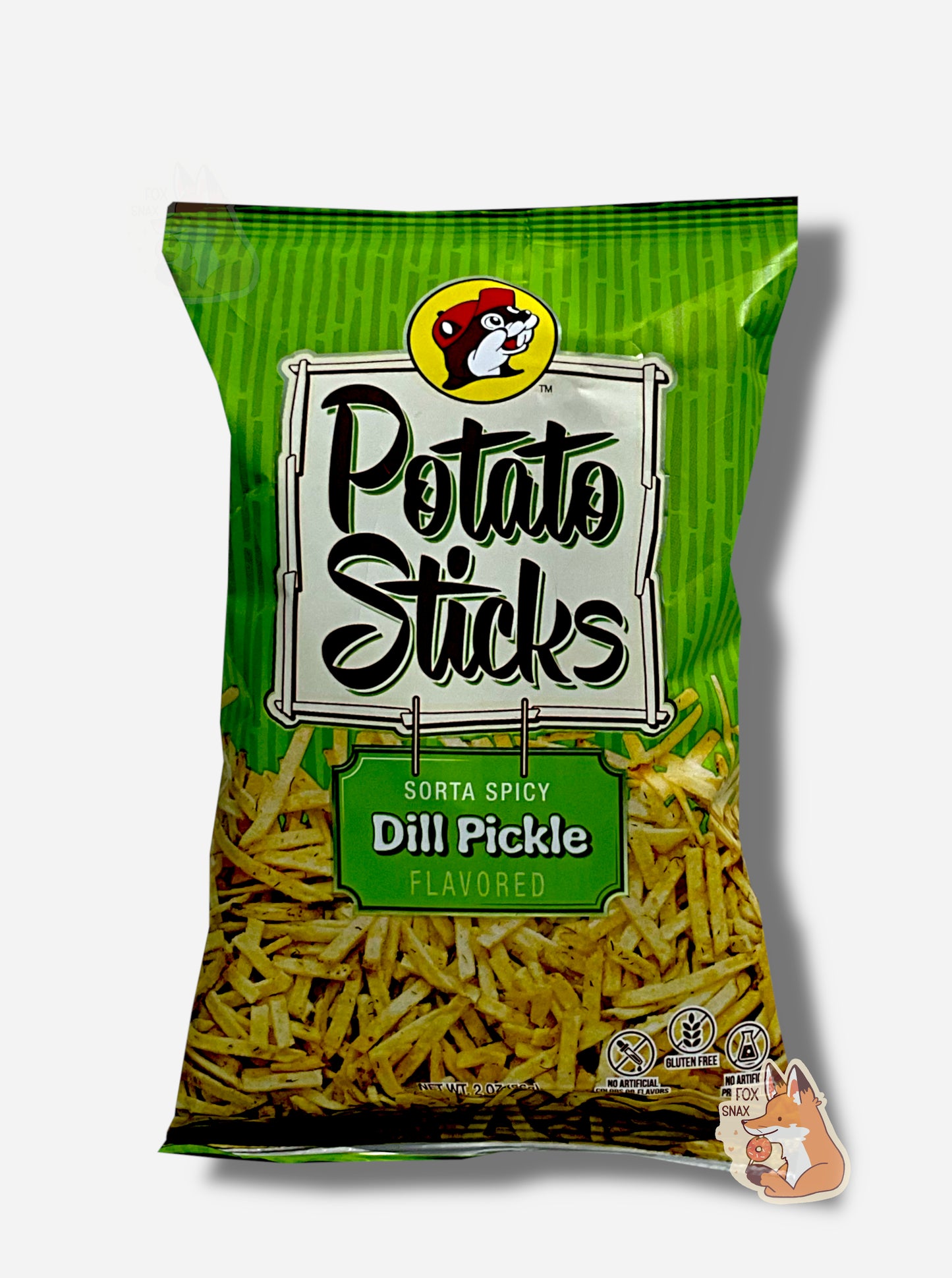 A bag of Buc-ee's Sorta Spicy Dill Pickle Flavored Potato Sticks. The bag is in dark and light green, and has a white sign in the middle in black text that reads POTATO STICKS, then under that, SORTA SPICY DILL PICKLE FLAVORED. A large number of skinny (skinnier than french fries) potato sticks frame the bottom of the bag.