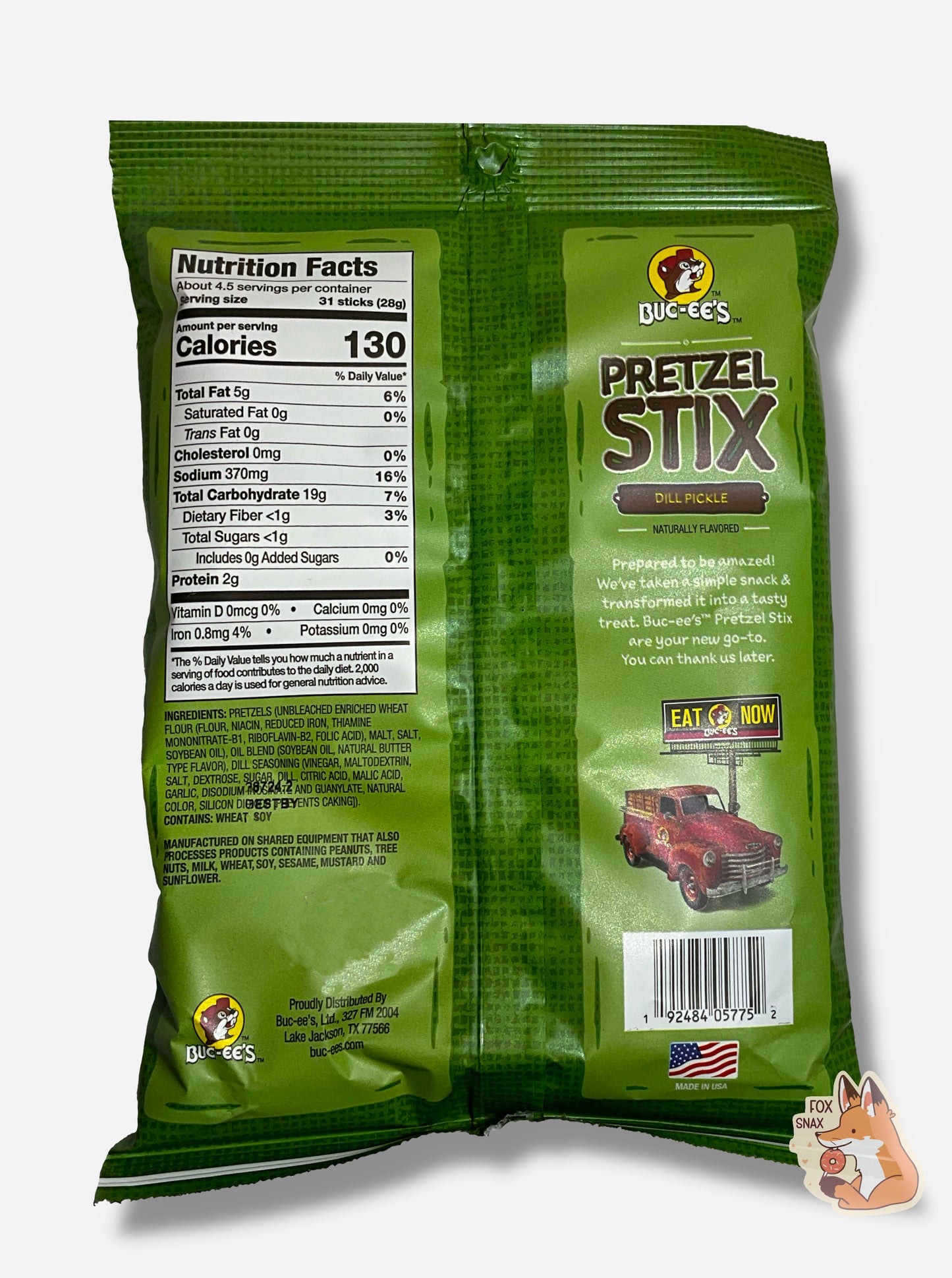 A picture of the back of a green bag of Buc-ee's Pretzel Stix, Dill Pickle flavor. The bag reads BUC-EE'S PRETZEL STIX, DILL PICKLE, NATURALLY FLAVORED, then in a small white font, "Prepared to be amazed! We've taken a simple snack & transformed it into a tasty treat. Buc-ee's Pretzel Stix are your new go-to. You can thank us later."