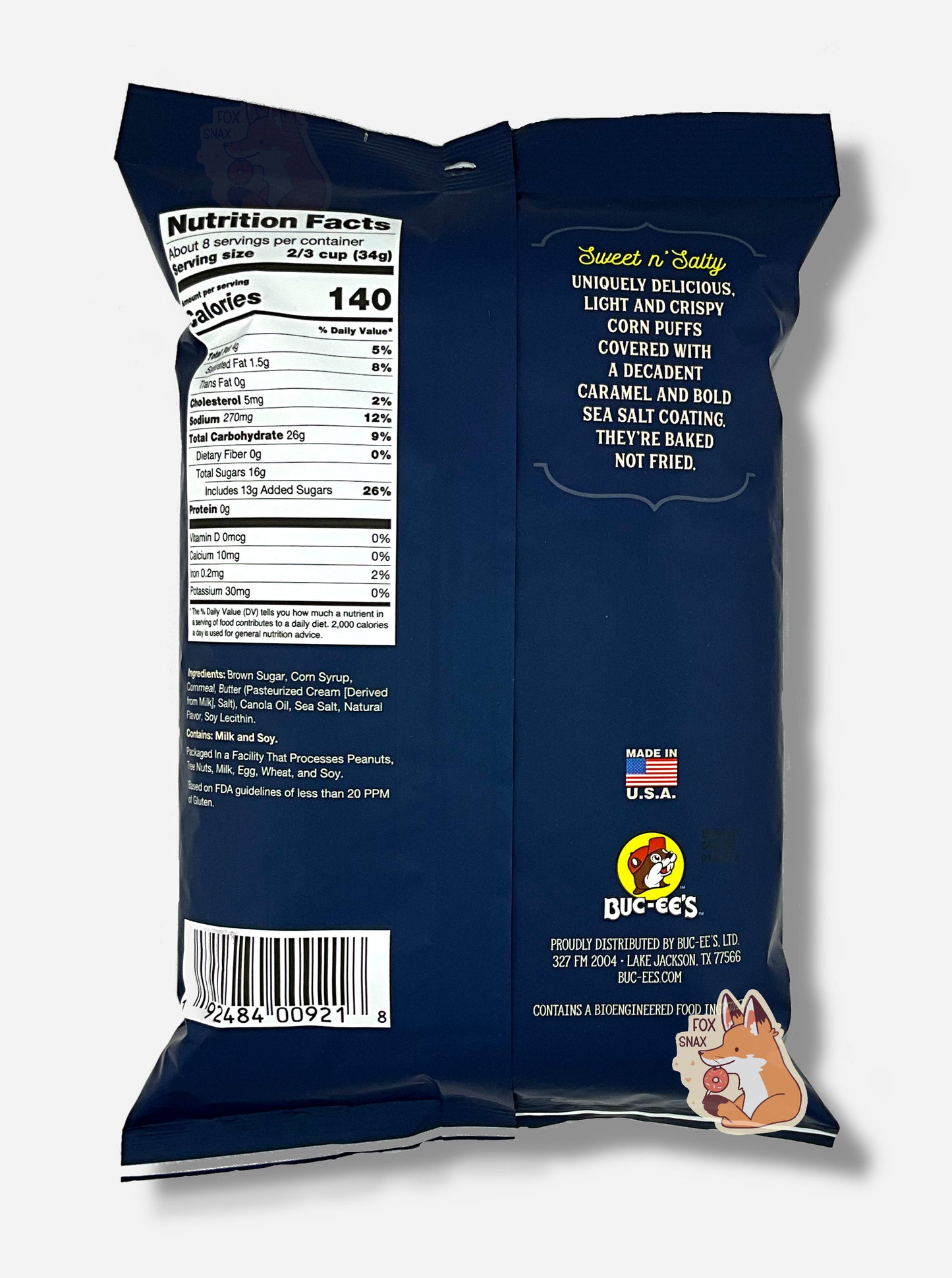 A picture of the back of a opaque, dark blue and white bag of Buc-ee's Sea Salted Caramel Beaver Nuggets. The bag reads: Sweet n' Salty, Uniquely delicious, Light And Crispy, Corn Puffs covered with a decadent caramel and bold sea salt coating. They're baked not fried.
