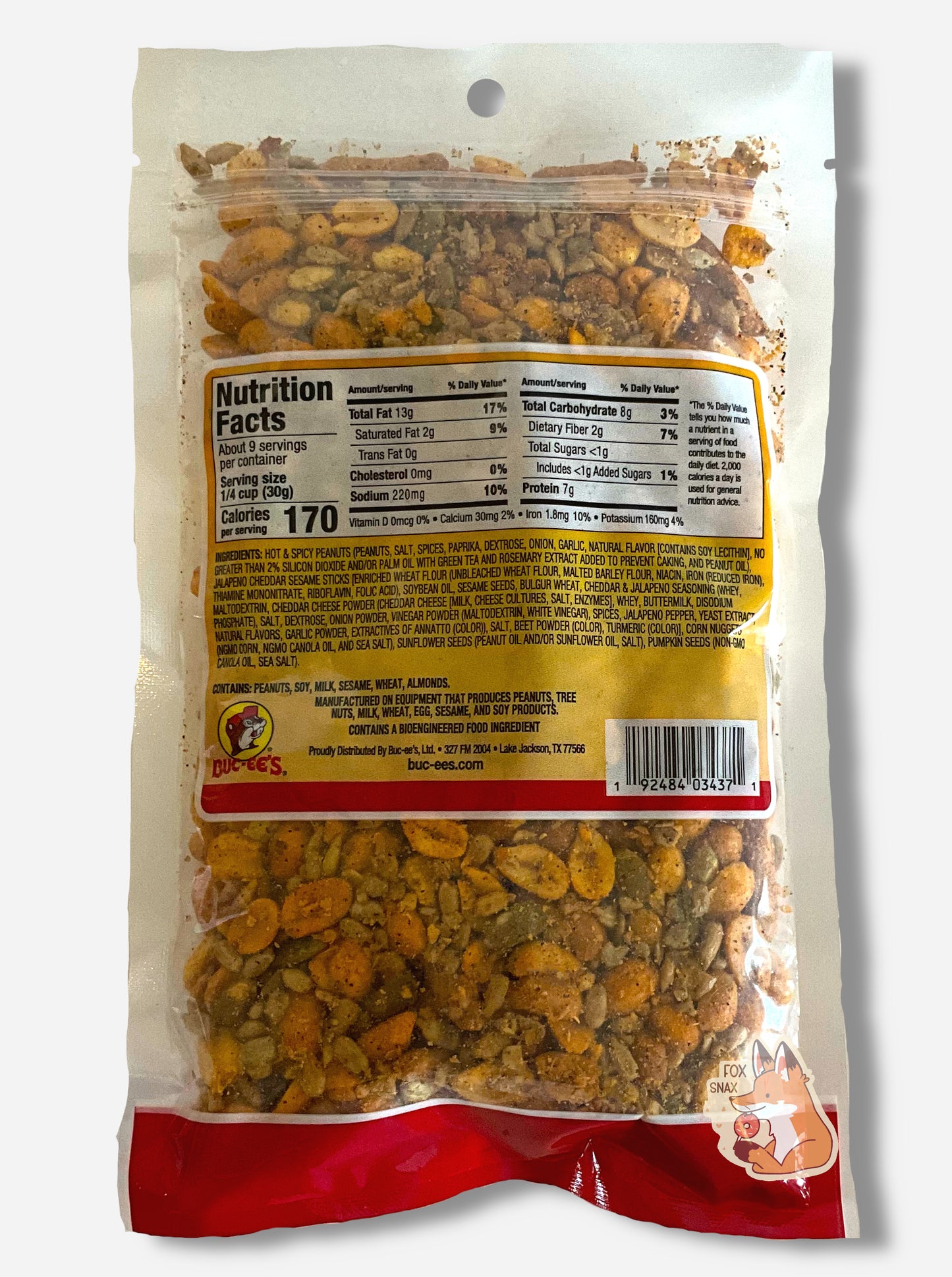 A picture of the back of bag of Buc-ee's Southwest trail mix. The bag is clear plastic, At the bottom, after the ingredient listing, peanuts, sesame sticks, corn nuggets, sunflower seeds, and pumpkin seeds can be seen. There appears to be a fair amount of spices on all the products.
