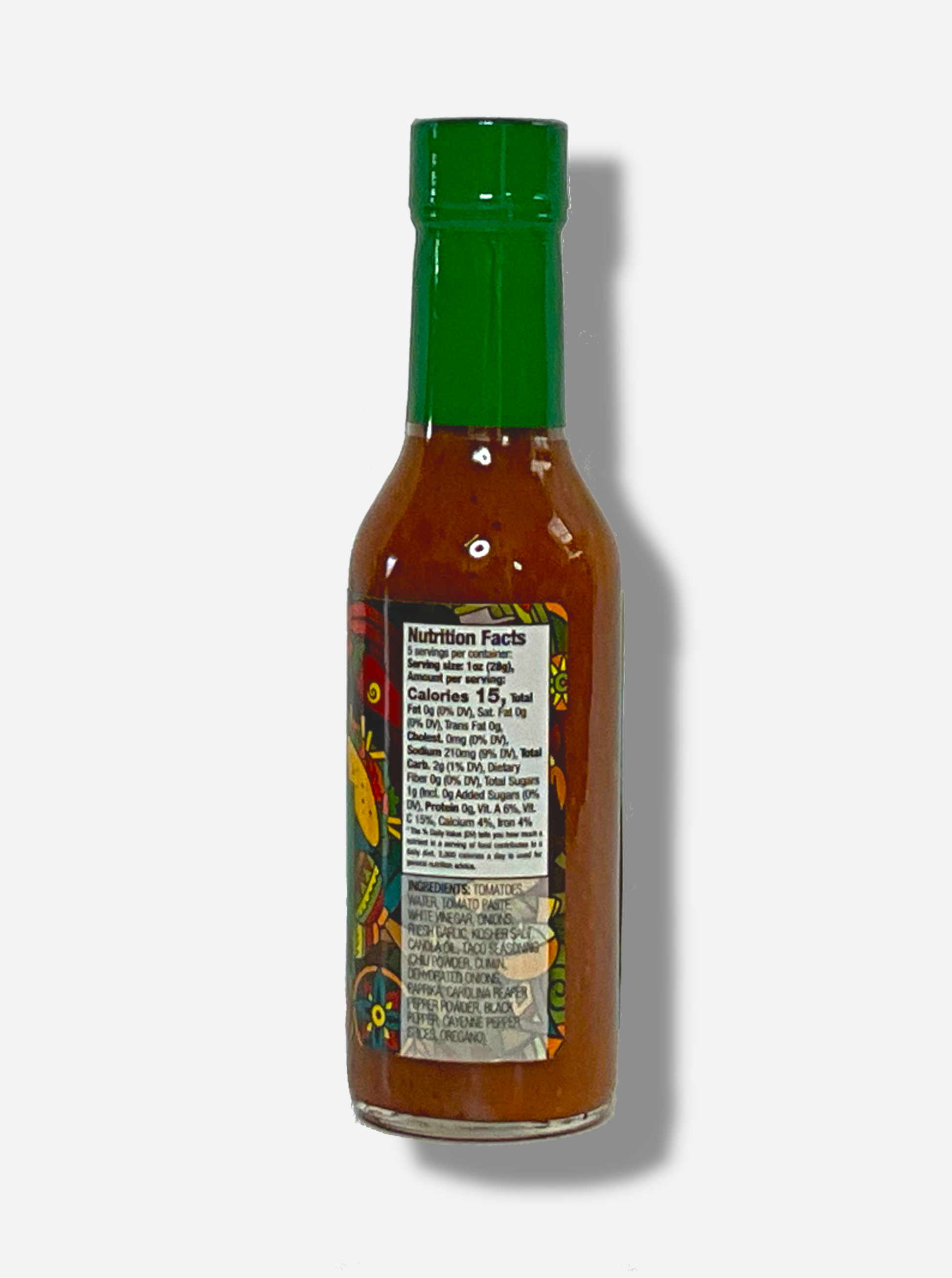 A picture of a small, tall glass bottle of hot sauce. The top of the bottle is sealed with a plastic top. The sauce inside is a yellow/tan color, with pepper seeds visible.