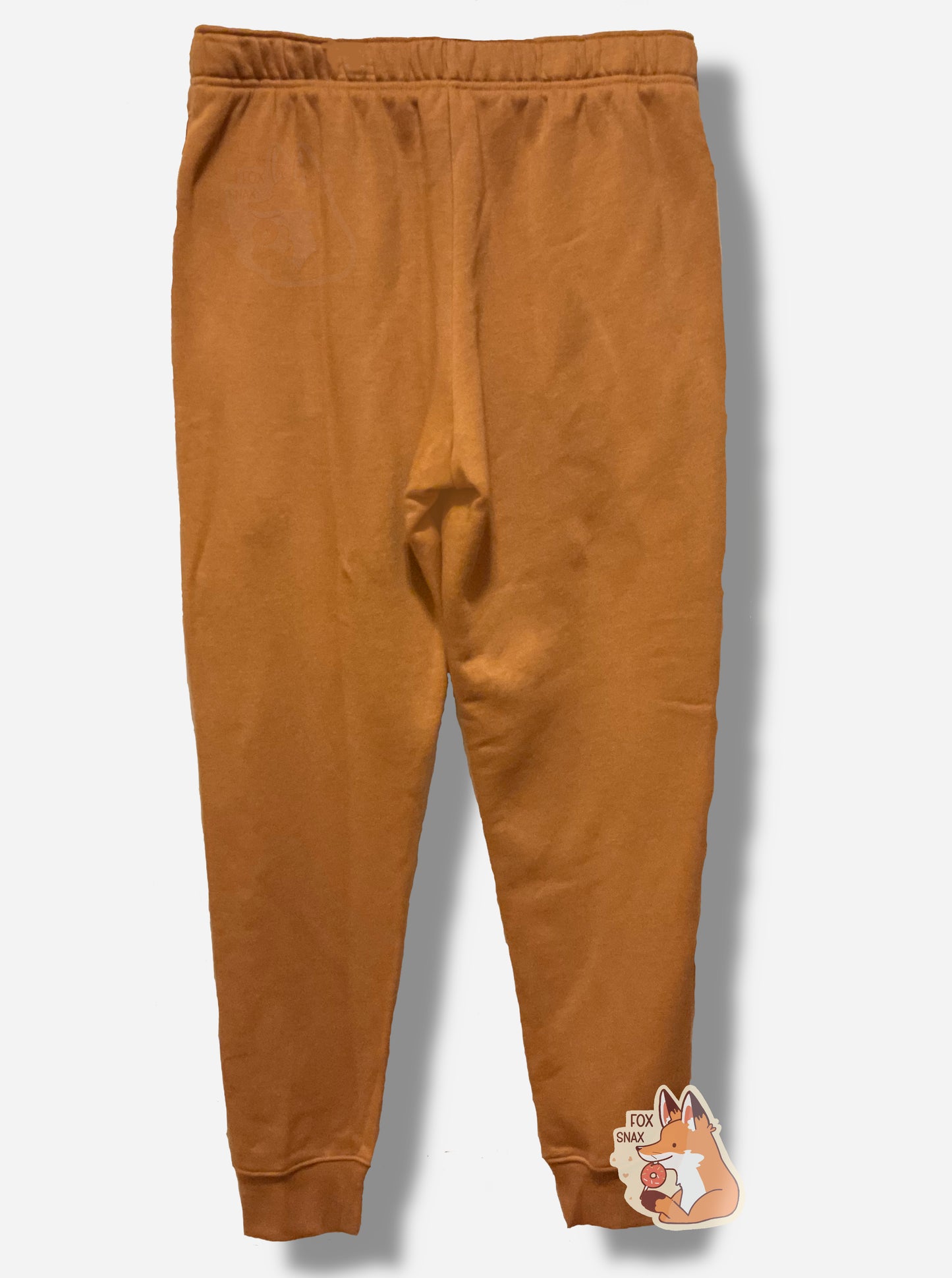 A picture of the back of a pair of tan fleece jogging pants.