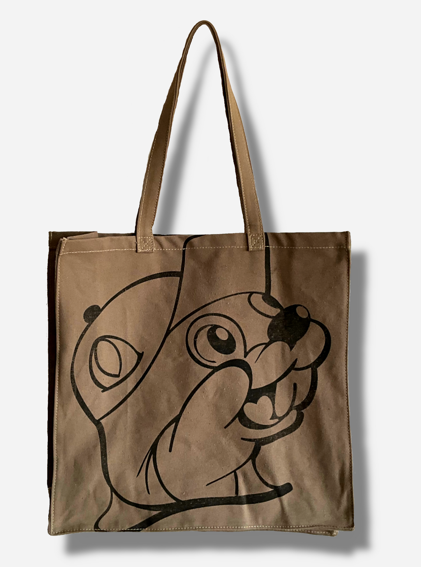 A picture of the back of a Buc-ee's Market Tote. The tote is a large, cloth, rectangular. flat bag. The front and back of the bag have a slightly faded black imprint of Buc-ee The Beaver's face. Two large cloth straps are sewn to the top of the bag to make it easy to carry.