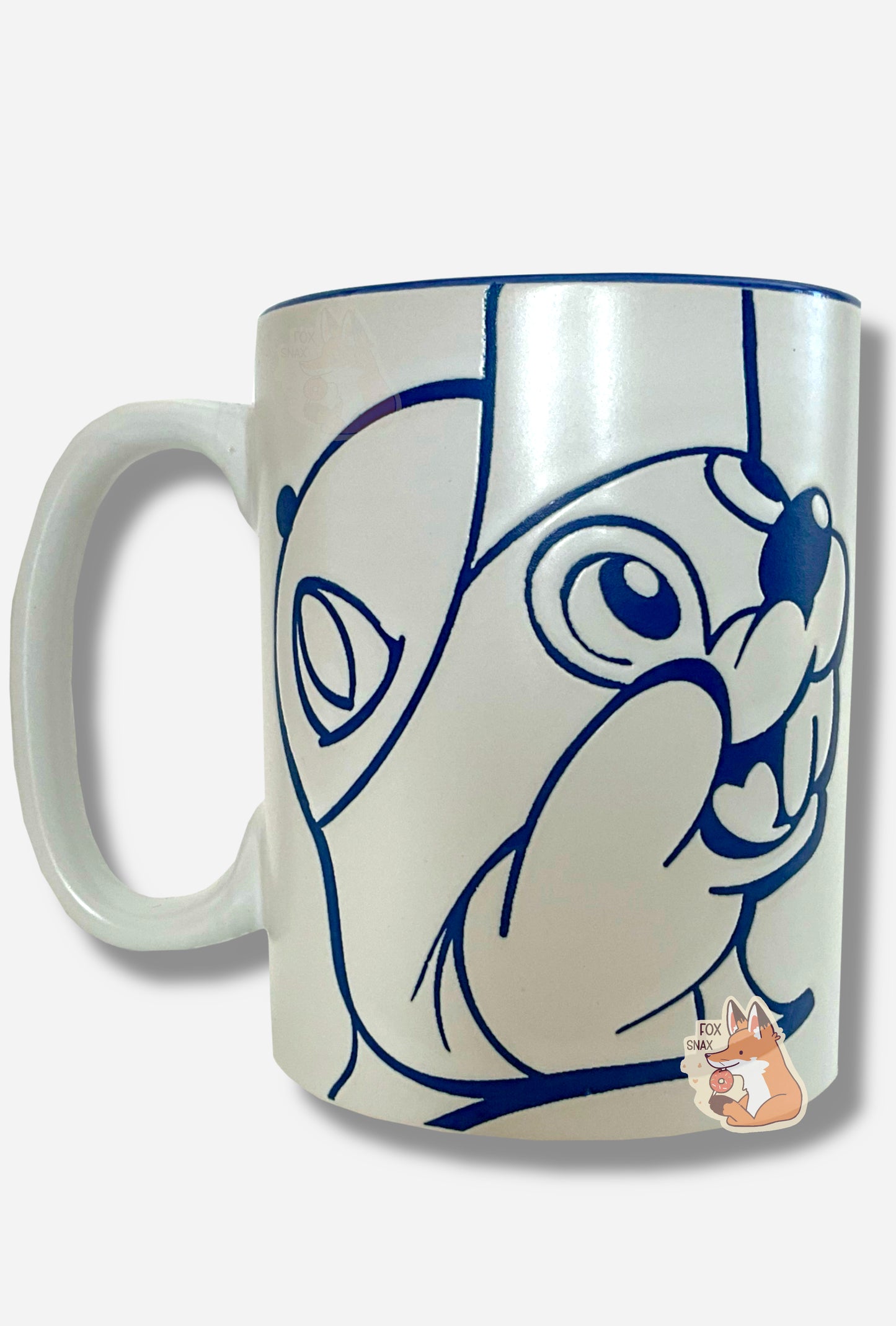 A picture of a ceramic, dark blue and white coffee mug. The mug prominently features a picture of Buc-ee The Beaver on the front and back, in dark blue. The interior of the mug is a dark blue as well, and rest of the mug is white.
