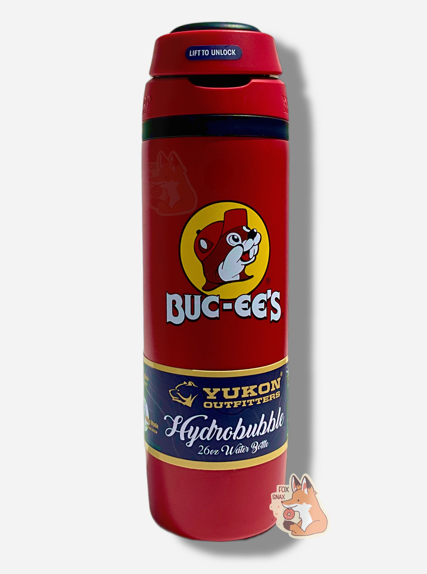 A picture of a tall red cylindrical water bottle, with a big picture of Buc-ee The Beaver on it.  It reads BUC-EE'S in a large white circular font.  The surface is smooth and red, as it is red paint covering stainless steel.  The small plastic handle is closed.  The top is black and red plastic, and is closed.  A paper wrapper around the bottom reads: Yukon Outfitters.  Hydrobubble 26oz Water Bottle.