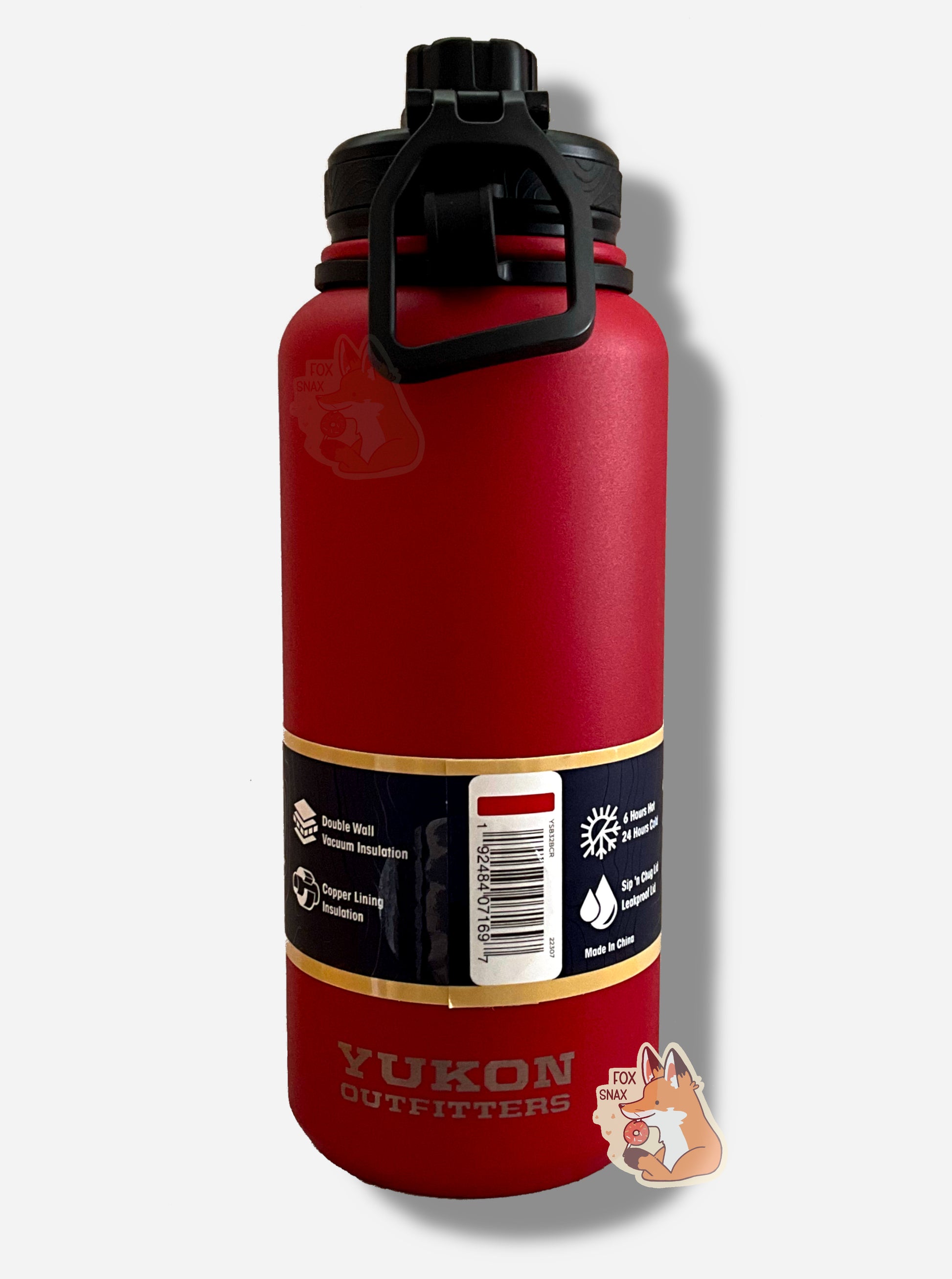 A picture of the back of a tall red cylindrical water bottle.  The surface is smooth and red, as it is red paint covering stainless steel.  There is no handle.  The top is a screw on plastic knob with a keychain handle.  Underneath the paper label, engraved text on the bottom reads: YUKON OUTFITTERS.