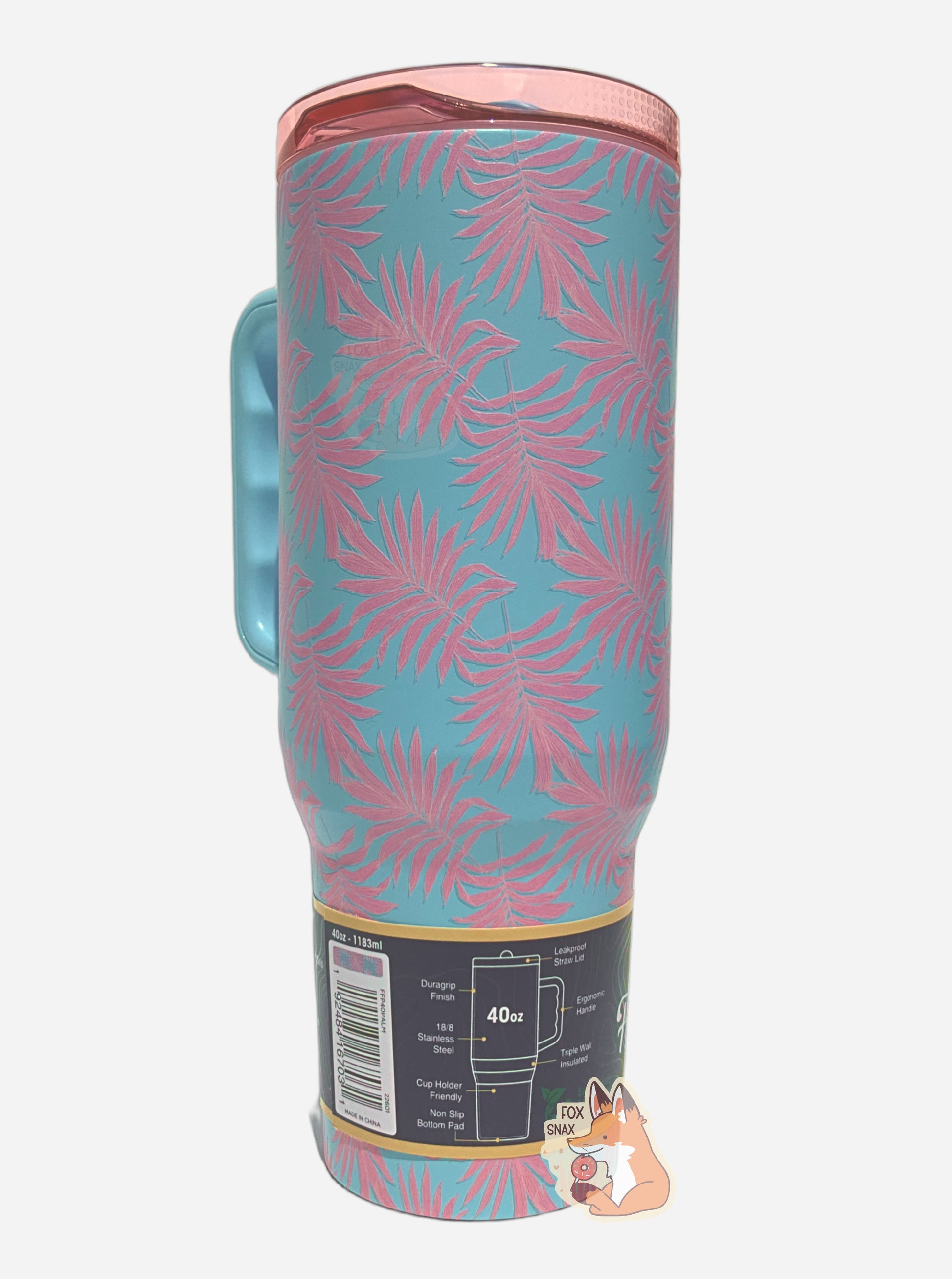 A picture of the back of a tall, light blue, sorta skinny tumbler.  The surface is light blue, and covered in light pink palm fronds.  It is matte paint in covering stainless steel.  The handle and sipper on top of the lid are light blue.  The top is light transparent pink plastic. 