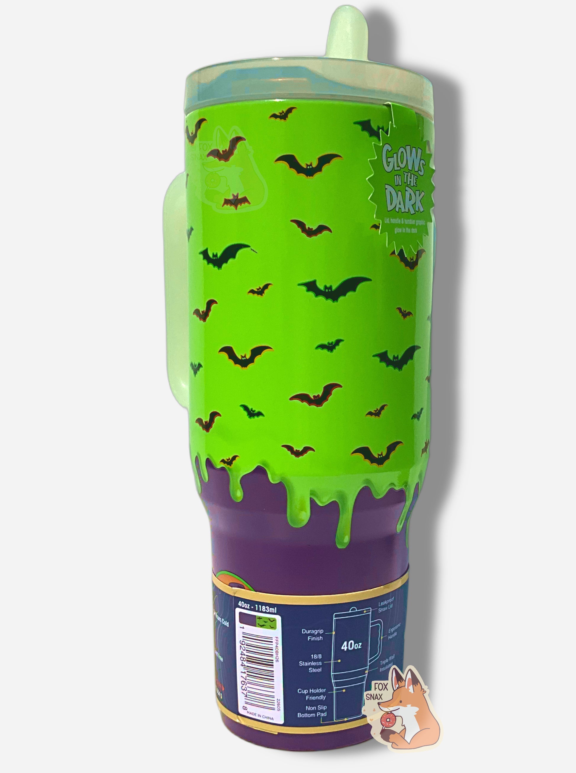 A picture of the side of a tall, green and purple sorta skinny tumbler. The surface  is bright green slime 'dripping' down the tumbler, with black bats against that background.  The bats have purple, green, and yellow outlines.  The bottom fades to solid purple. The tumbler is paint covering stainless steel. The handle and top are glow in the dark plastic.  