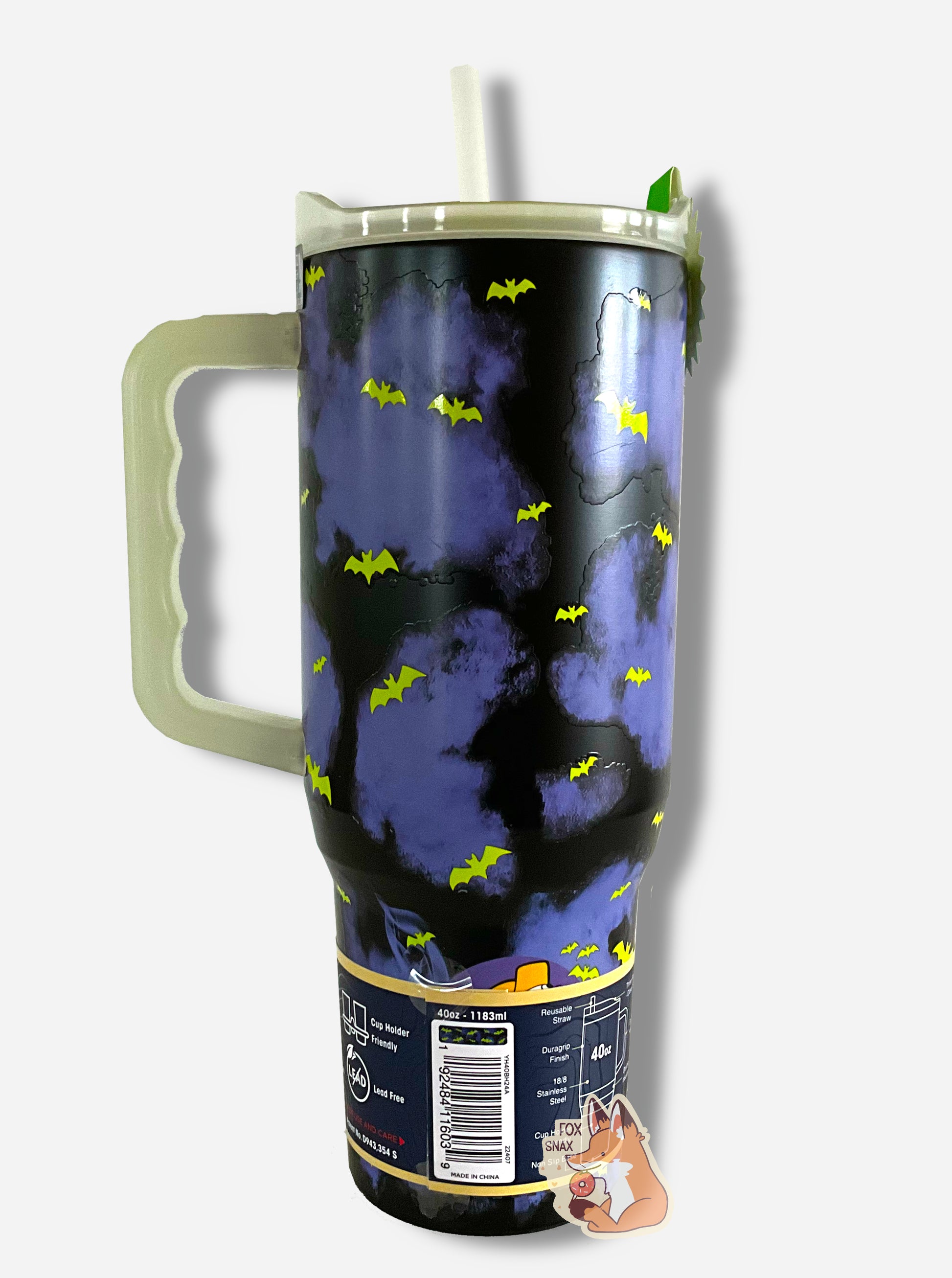 A picture of the back of a tall, dark blue and black, sorta skinny tumbler.  The surface is covered in purple and black clouds, and glow in the dark bats dot the surface.  The handle, top, and straw are plastic.  The top of the mug is lined with a stainless steel band.  A paper wrapper around the bottom has a diagram that reads 40 oz, next to the barcode.